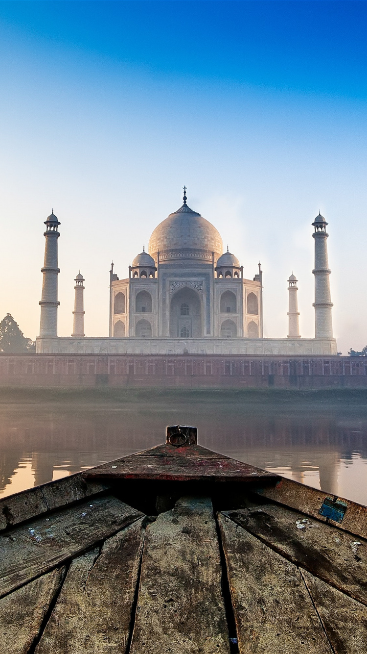 White Concrete Building Near Body of Water During Daytime. Wallpaper in 750x1334 Resolution