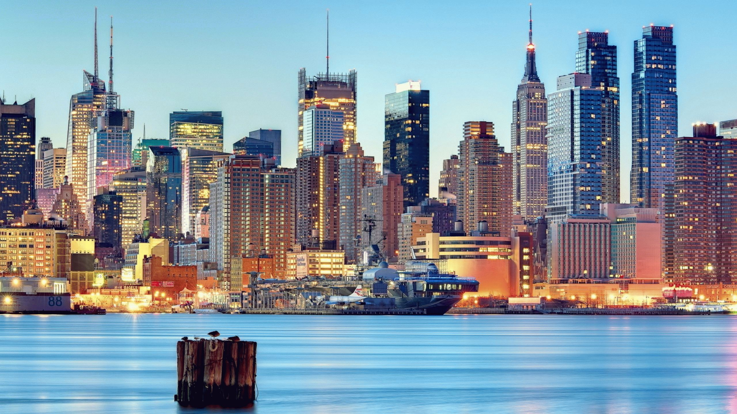 City Skyline Across Body of Water During Daytime. Wallpaper in 2560x1440 Resolution