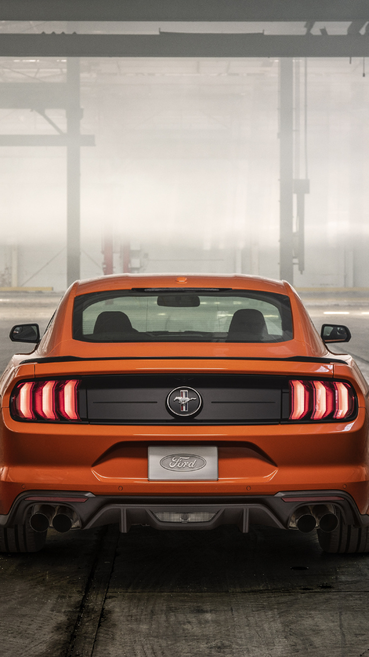 Red Chevrolet Camaro in a Parking Lot. Wallpaper in 750x1334 Resolution