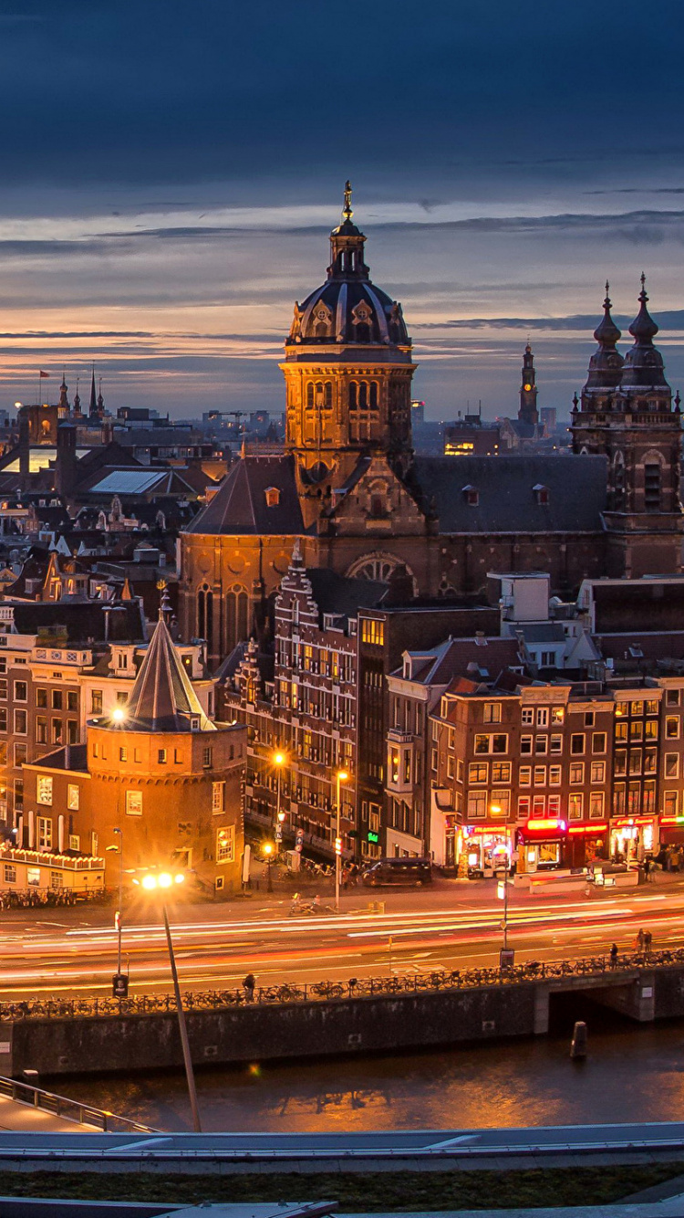 City Buildings Near Body of Water During Night Time. Wallpaper in 750x1334 Resolution