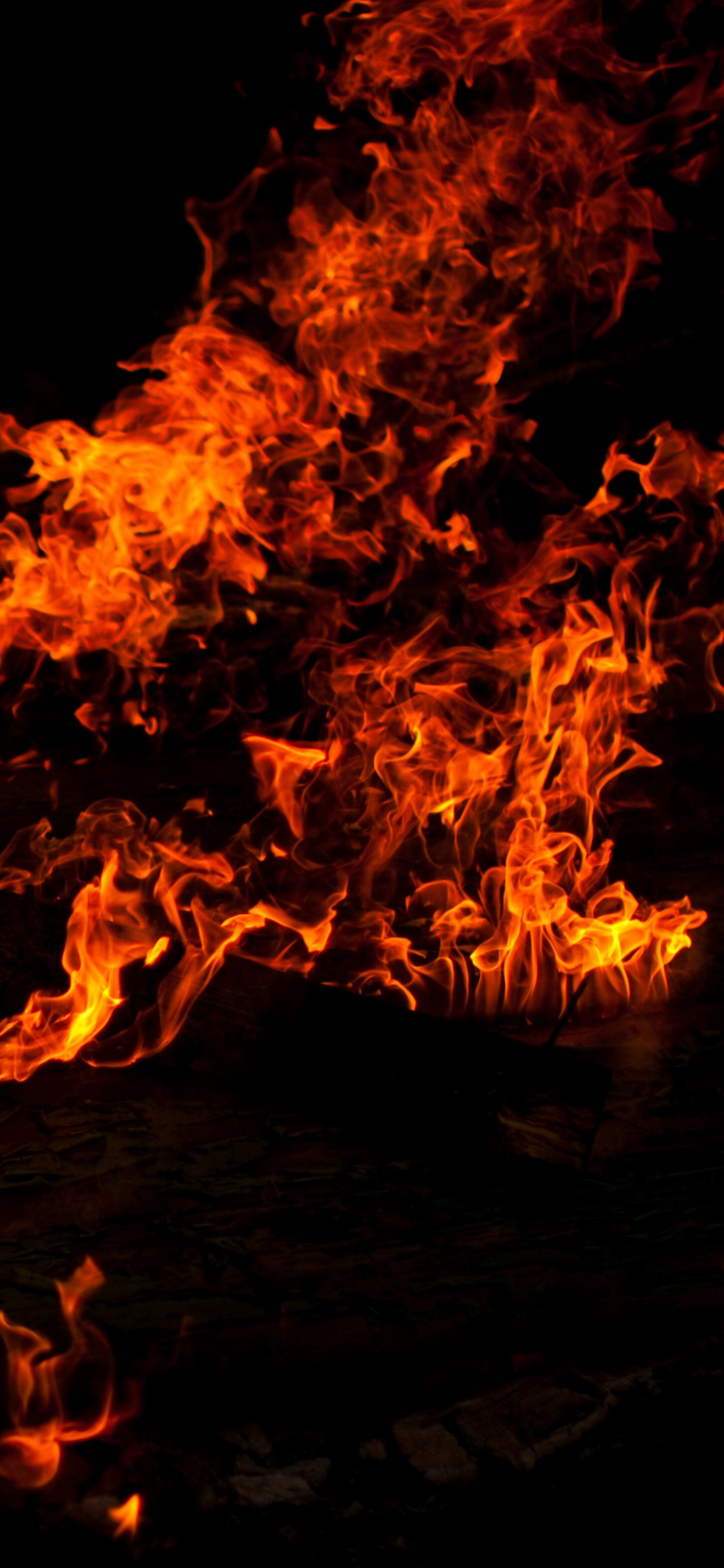 Fire on Fire During Night Time. Wallpaper in 1125x2436 Resolution