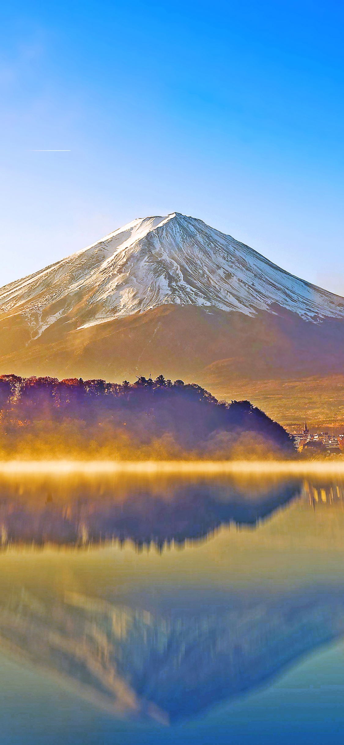Lake Near Mountain Under Blue Sky During Daytime. Wallpaper in 1125x2436 Resolution