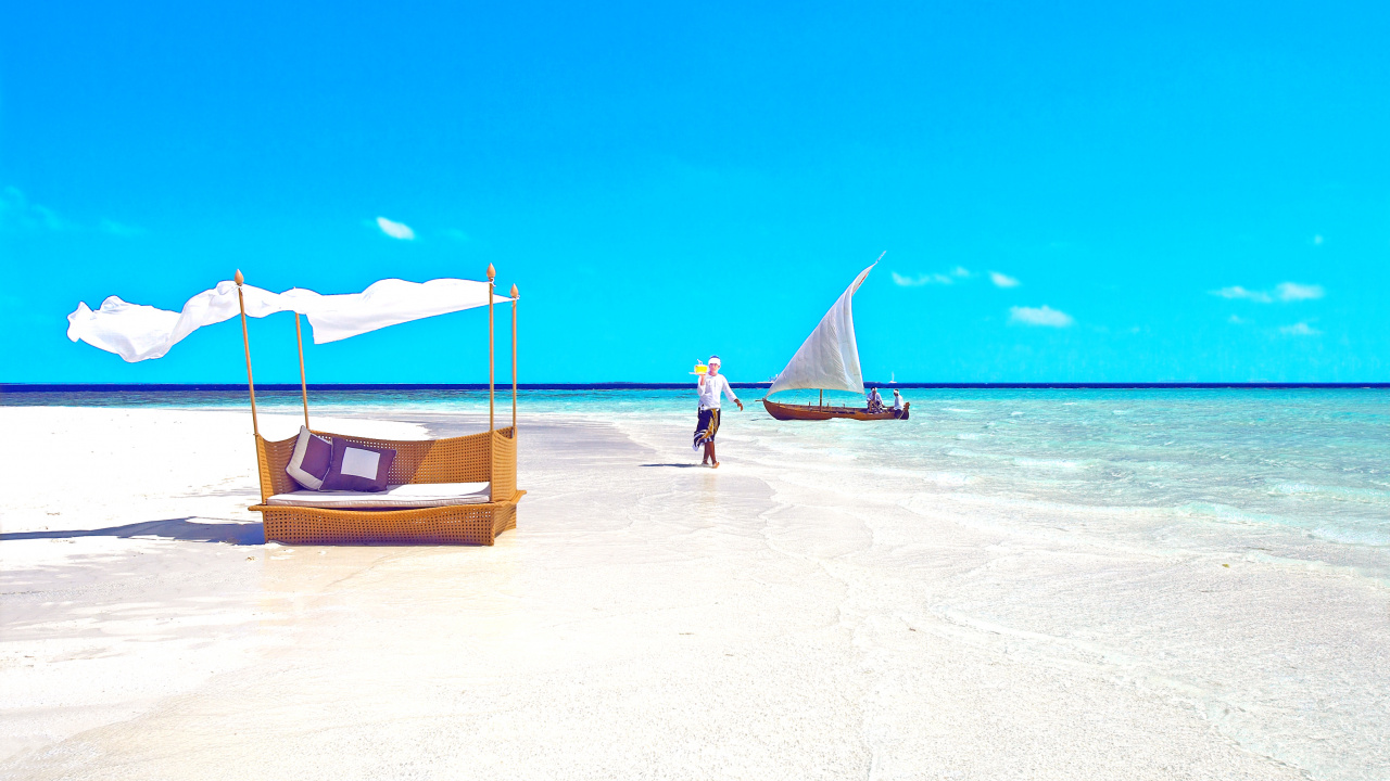 Person in Blue Shirt Standing on Beach During Daytime. Wallpaper in 1280x720 Resolution