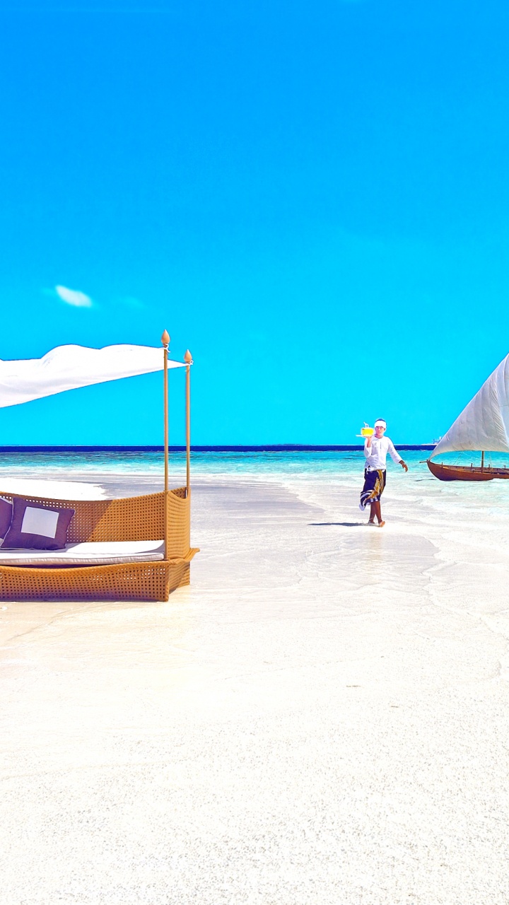 Person in Blue Shirt Standing on Beach During Daytime. Wallpaper in 720x1280 Resolution