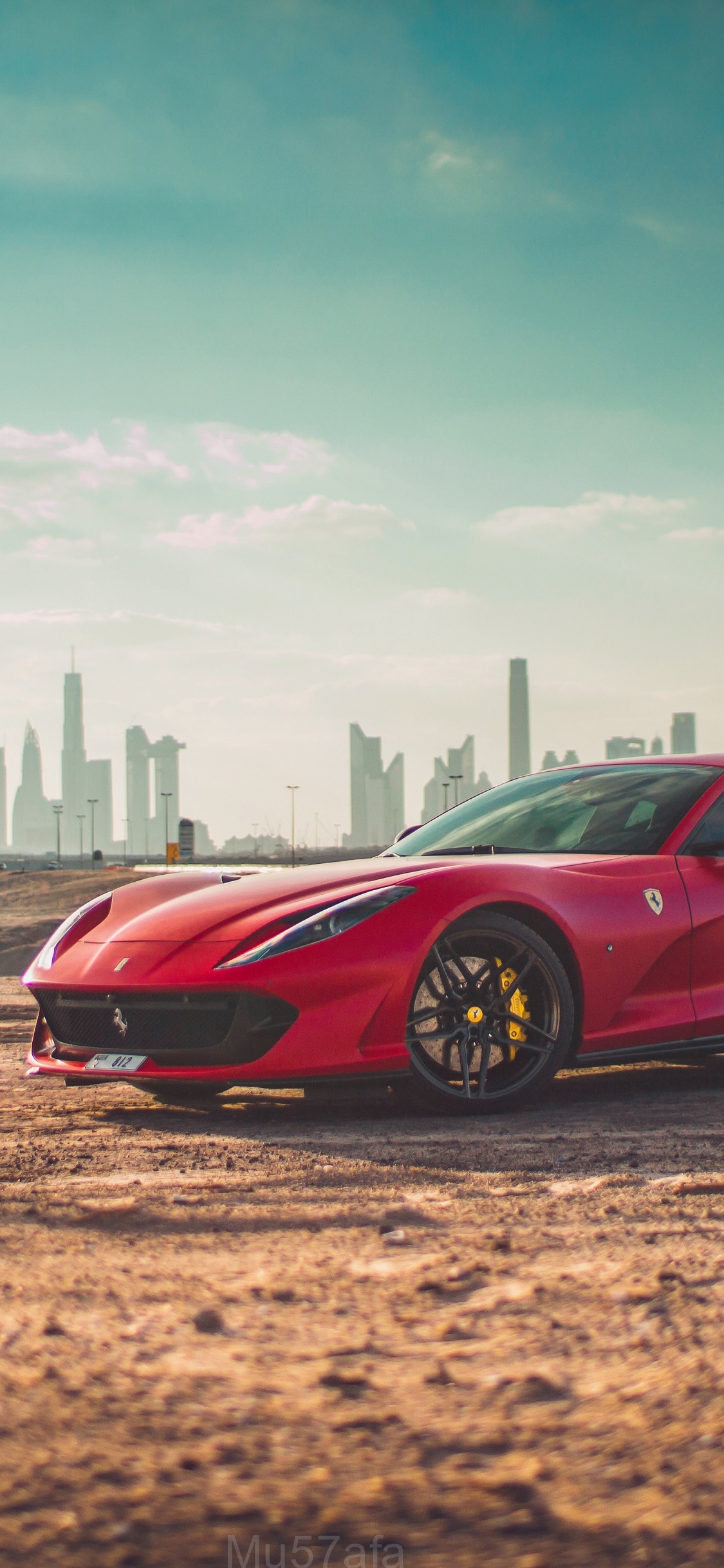 Red Ferrari 458 Italia on Brown Field. Wallpaper in 1125x2436 Resolution