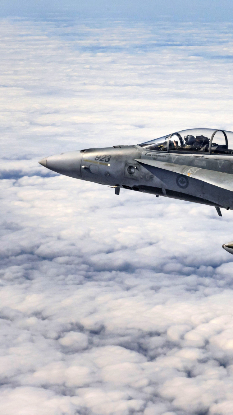 Black Jet Plane Flying Over White Clouds During Daytime. Wallpaper in 750x1334 Resolution