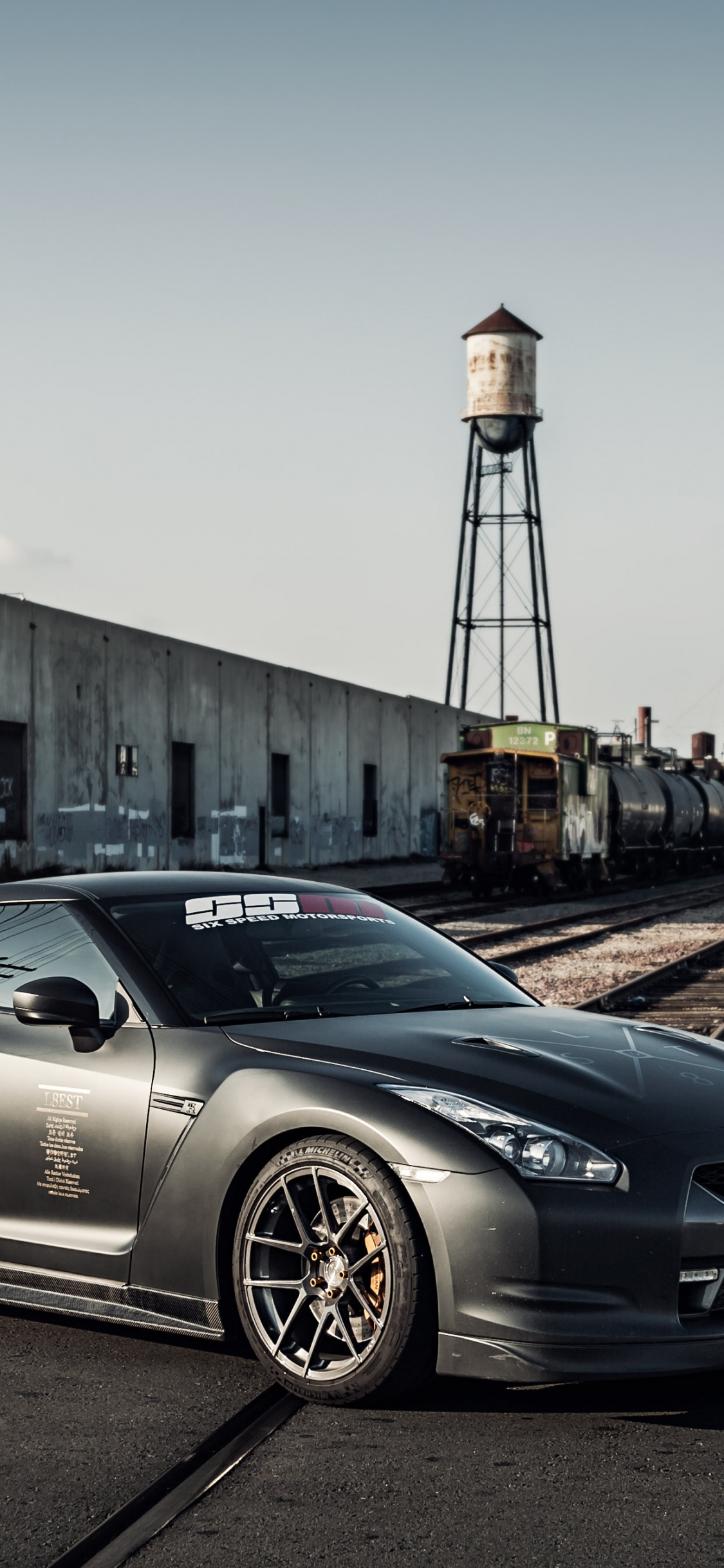 Black Porsche 911 Parked on Road During Daytime. Wallpaper in 1125x2436 Resolution