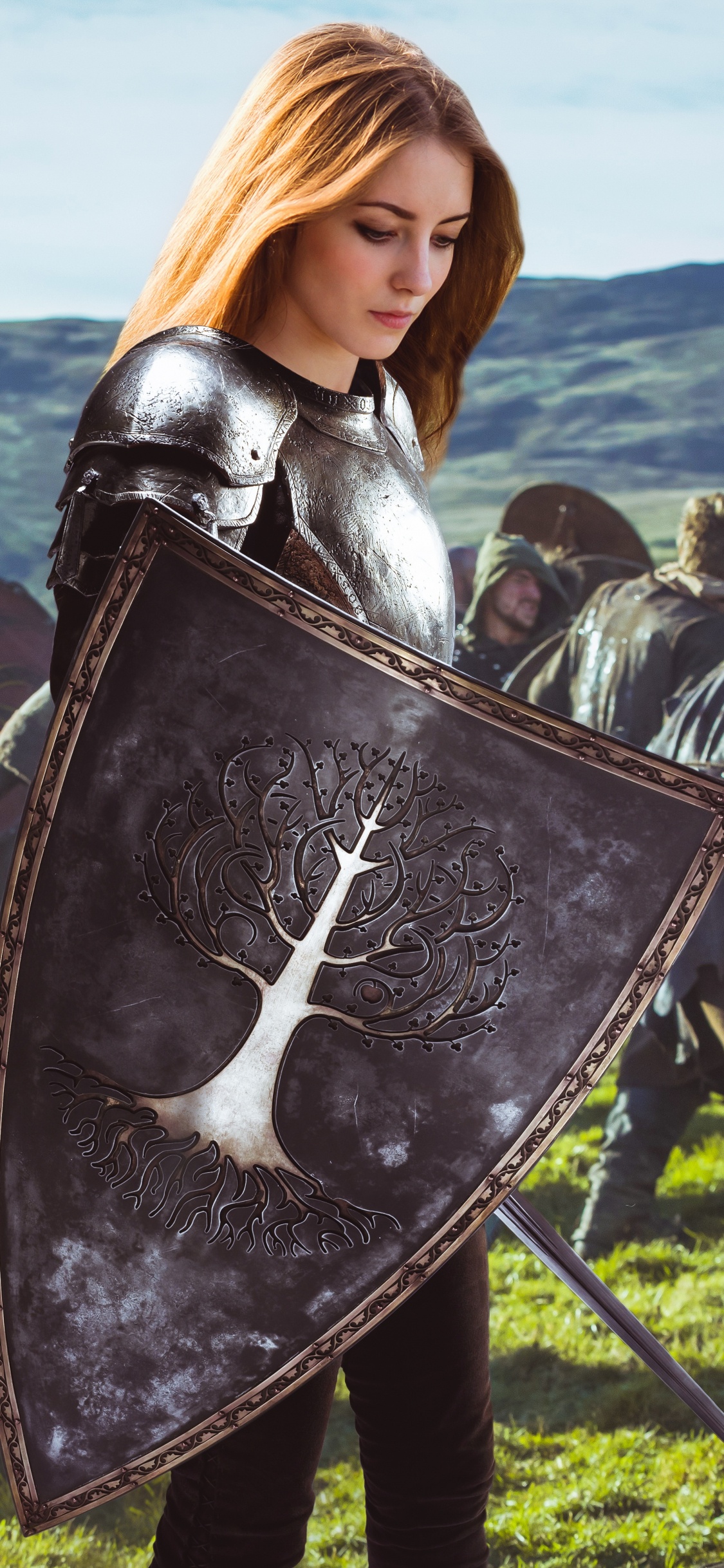 Woman in Black Leather Jacket Holding Black Shield. Wallpaper in 1125x2436 Resolution