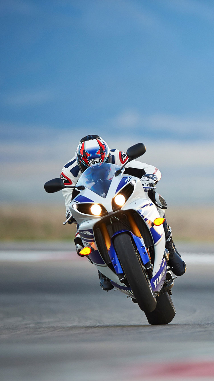 Man Riding on Yellow and White Sports Bike. Wallpaper in 750x1334 Resolution