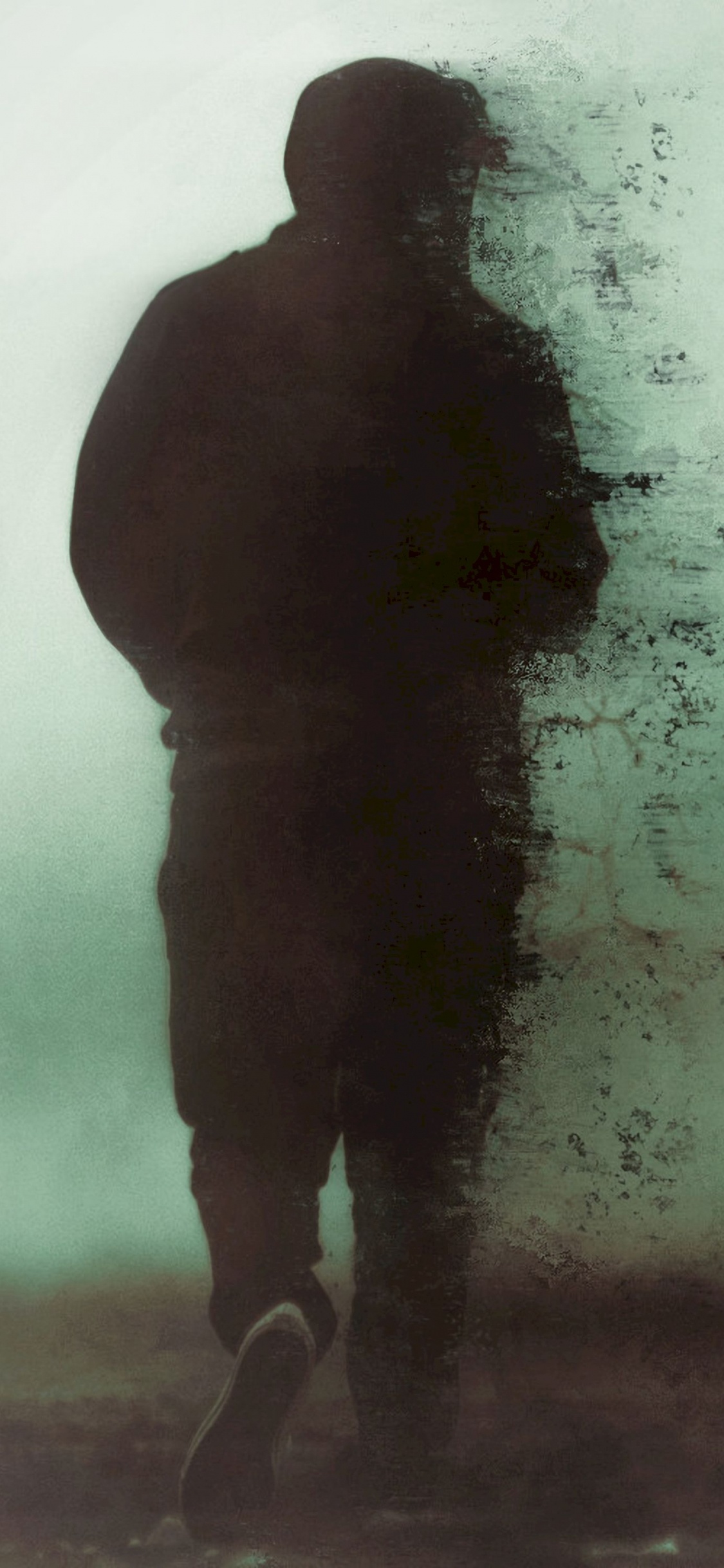 Hombre de Chaqueta Negra de Pie Sobre un Suelo Cubierto de Nieve. Wallpaper in 1125x2436 Resolution