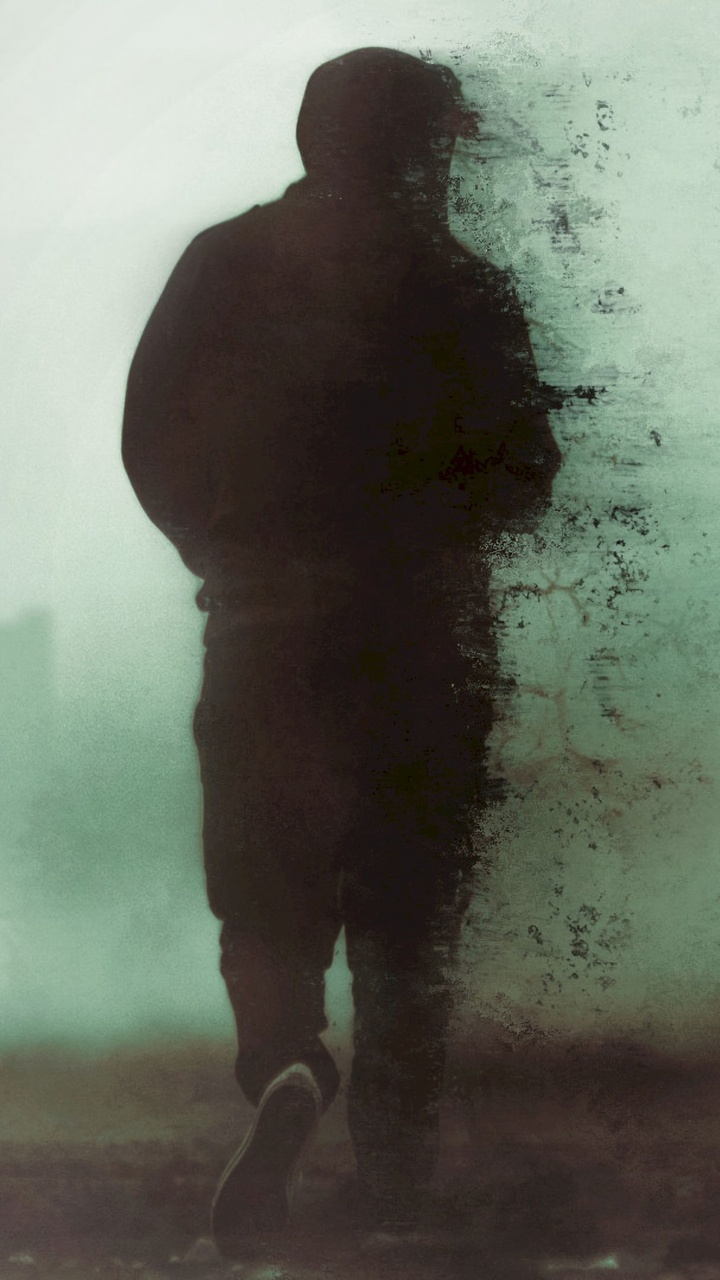 Man in Black Jacket Standing on Snow Covered Ground. Wallpaper in 720x1280 Resolution