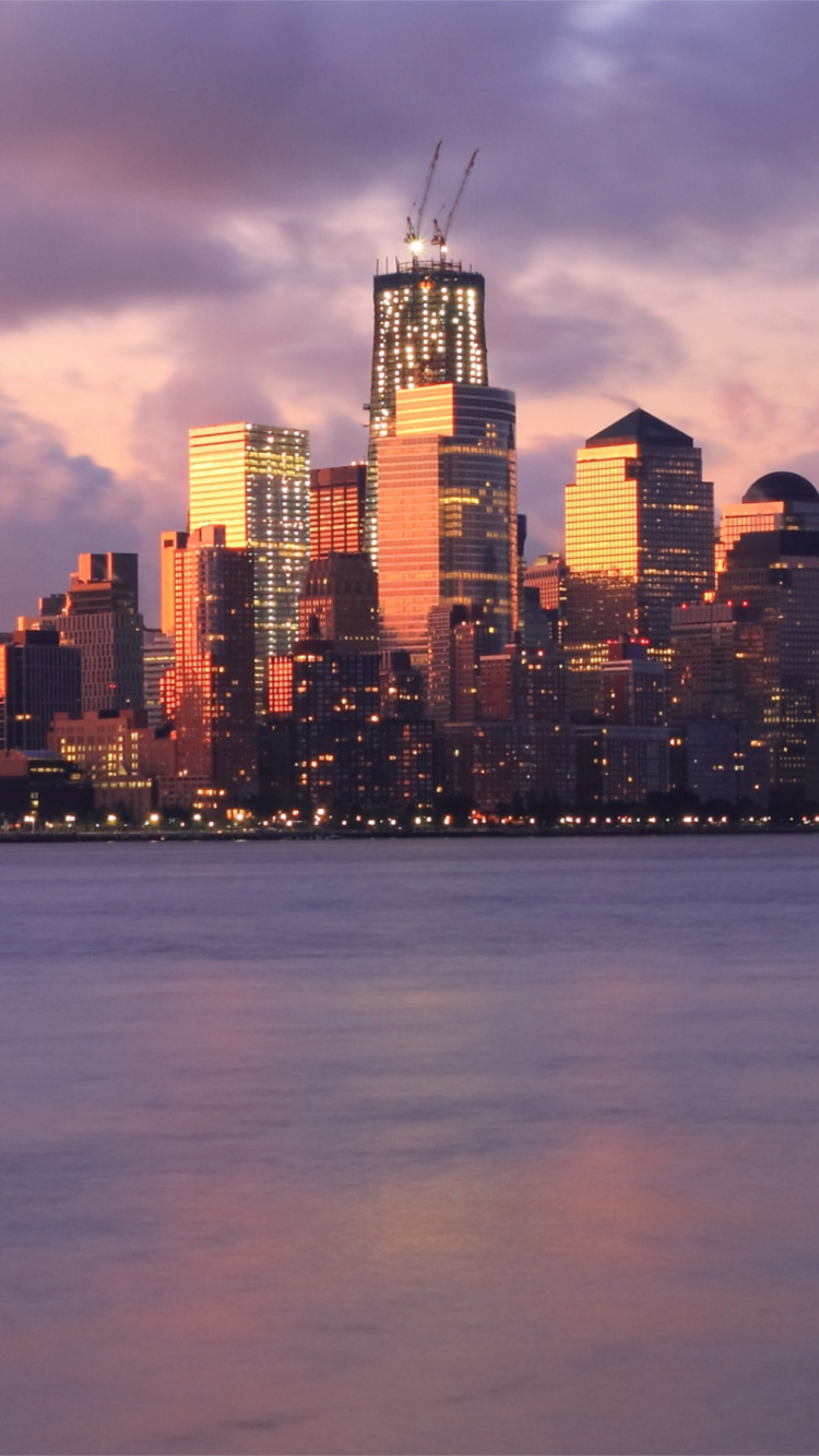 City Skyline Across Body of Water During Night Time. Wallpaper in 750x1334 Resolution