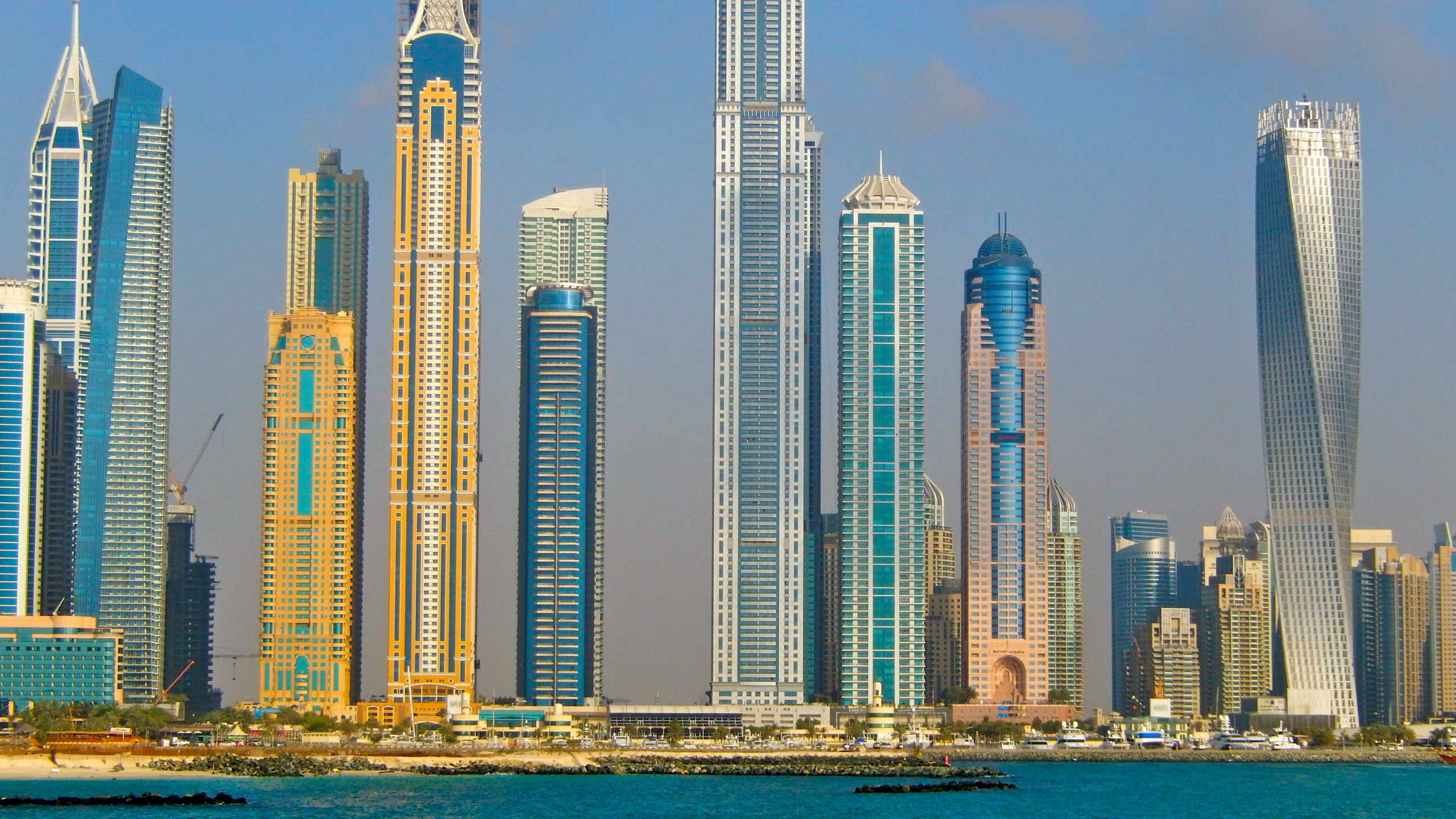 White High Rise Building Near Body of Water During Daytime. Wallpaper in 2560x1440 Resolution