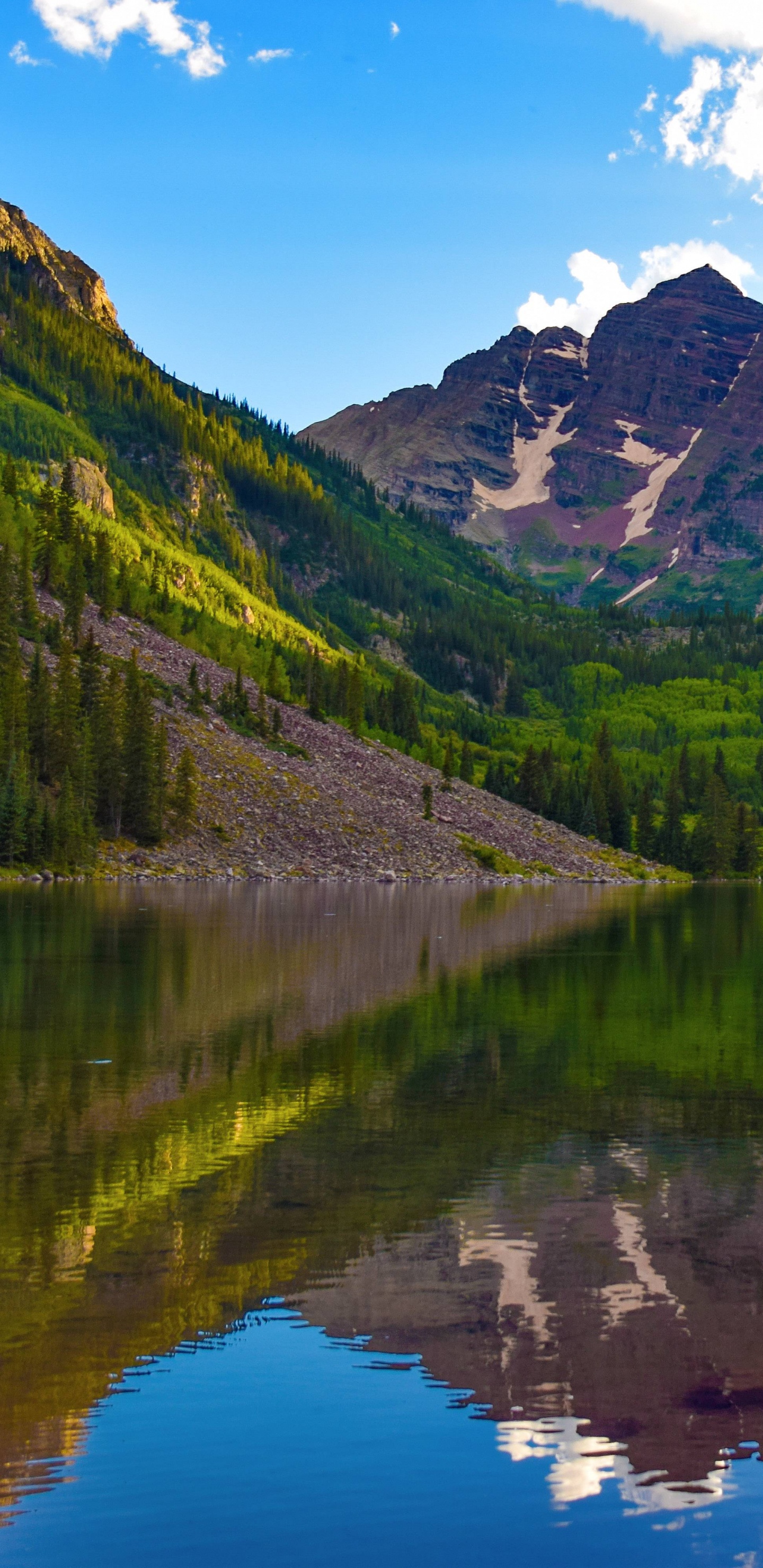 Green Mountains Beside Lake Under Blue Sky During Daytime. Wallpaper in 1440x2960 Resolution