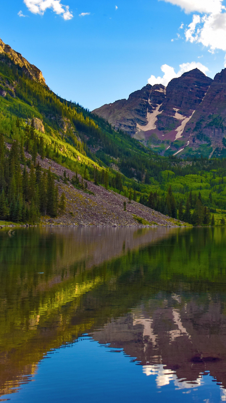 Green Mountains Beside Lake Under Blue Sky During Daytime. Wallpaper in 750x1334 Resolution