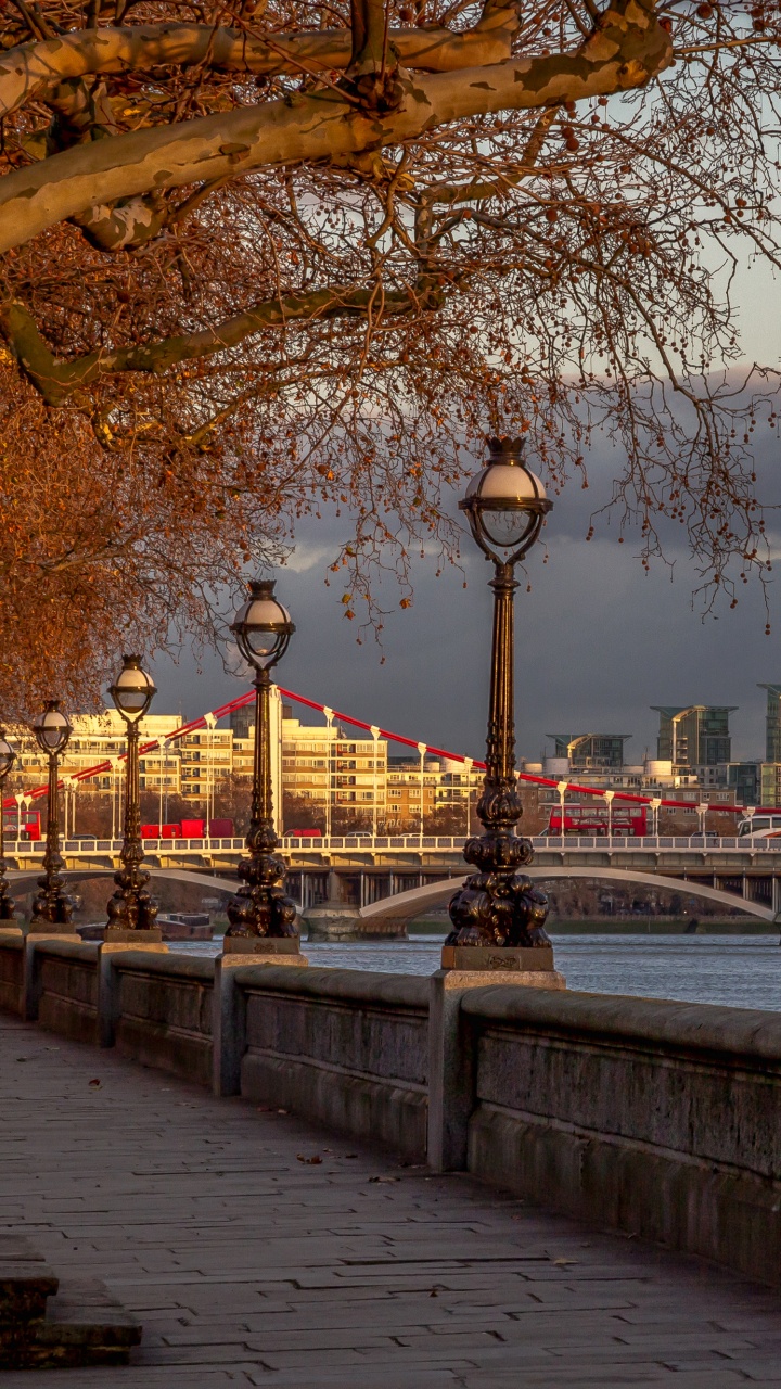 Black Street Lamp Near Body of Water During Sunset. Wallpaper in 720x1280 Resolution