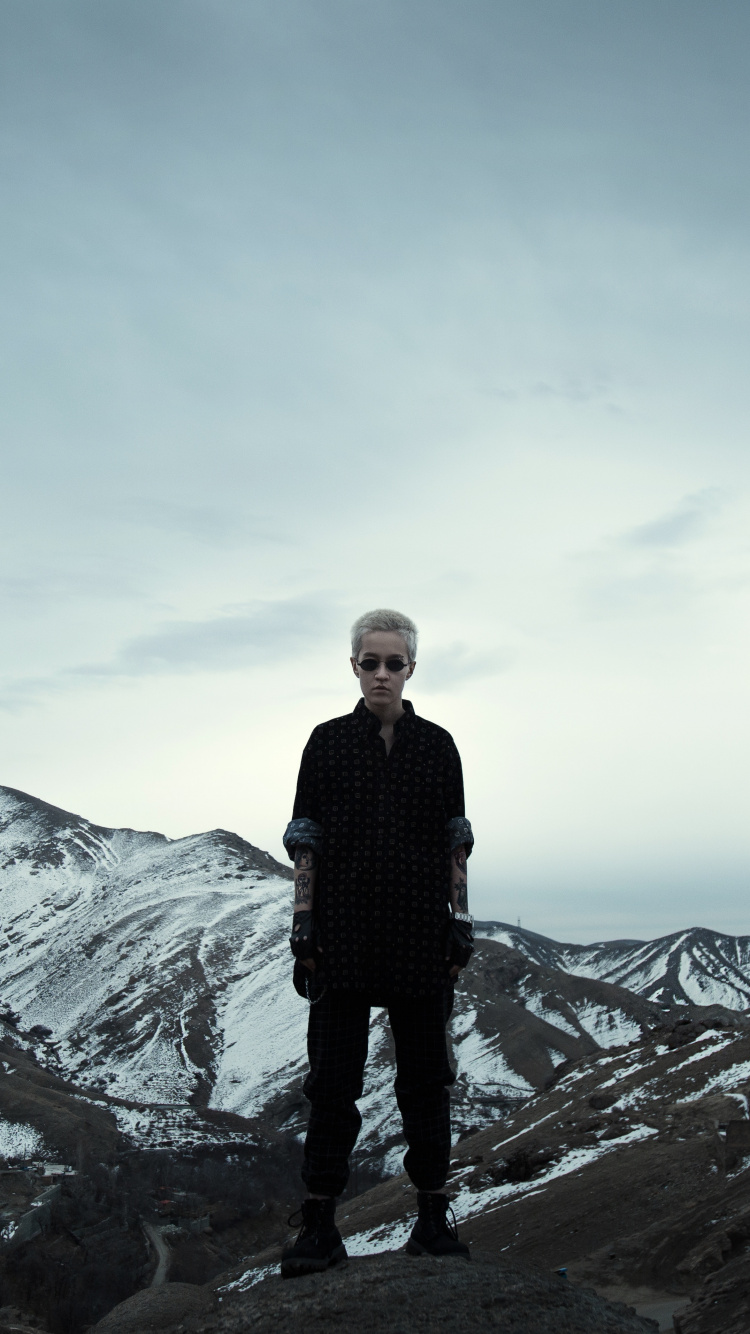 Man in Black Jacket Standing on Rock Formation During Daytime. Wallpaper in 750x1334 Resolution