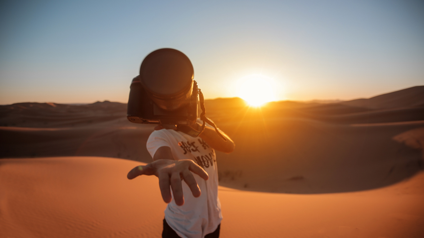 Man in White Shirt and Black Pants Standing on Sand During Sunset. Wallpaper in 1366x768 Resolution