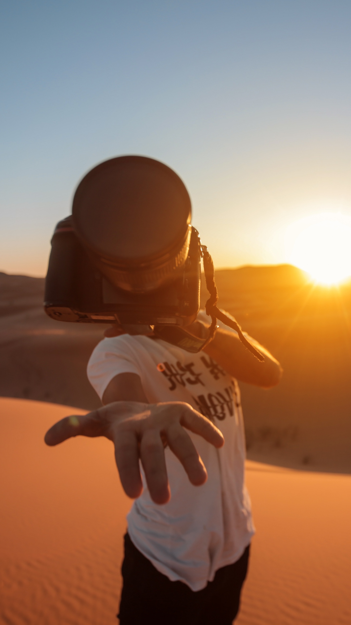 Man in White Shirt and Black Pants Standing on Sand During Sunset. Wallpaper in 1440x2560 Resolution