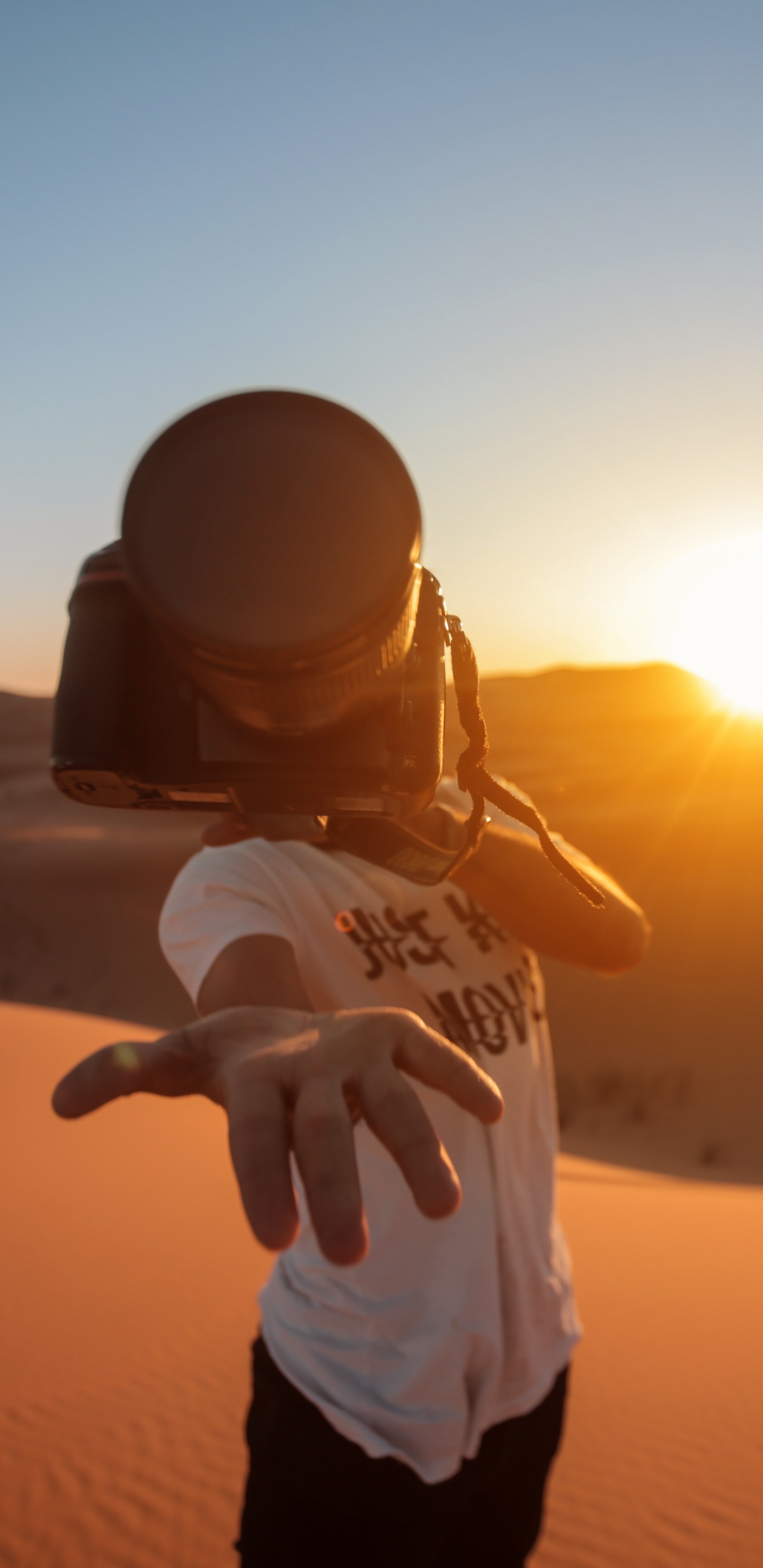 Man in White Shirt and Black Pants Standing on Sand During Sunset. Wallpaper in 1440x2960 Resolution