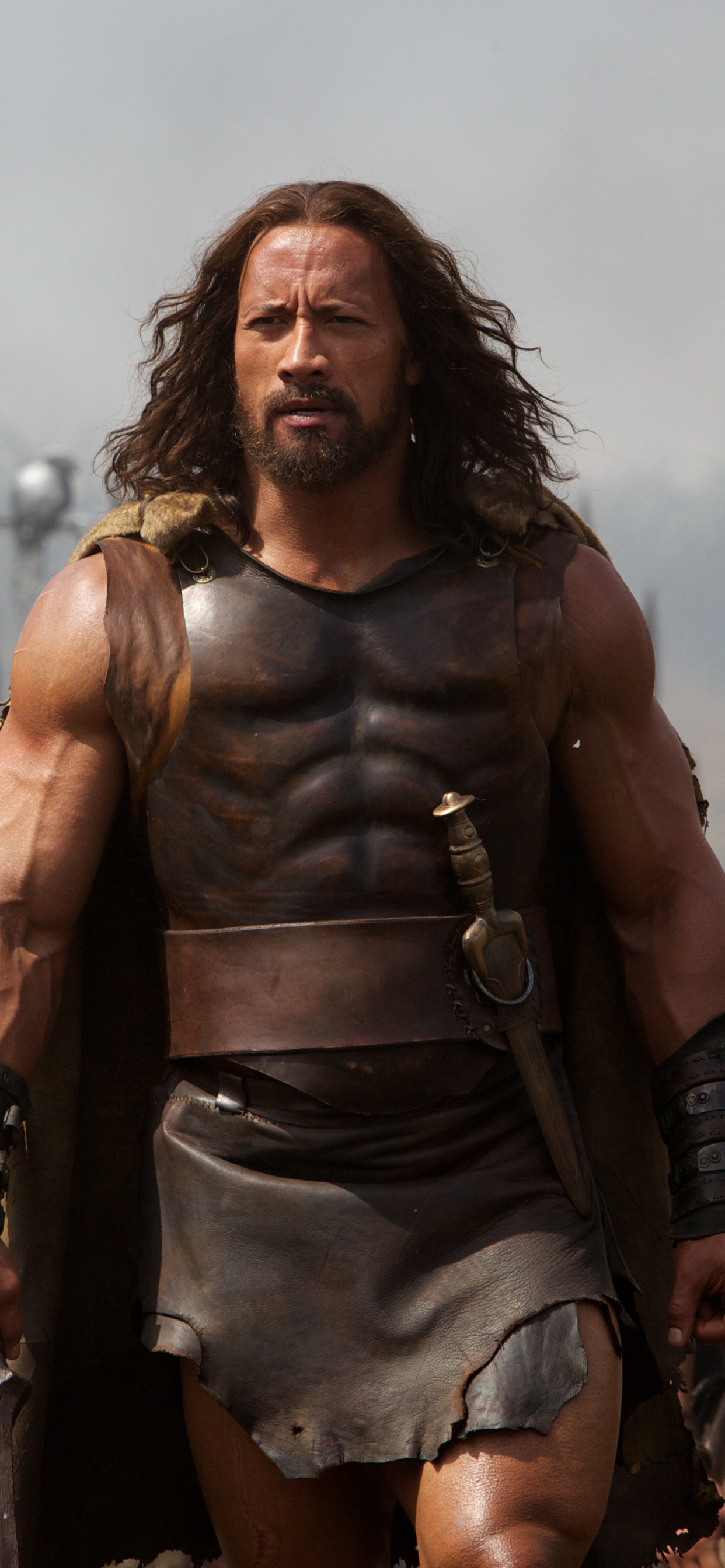 Woman in Brown Leather Jacket Standing on Field. Wallpaper in 1242x2688 Resolution