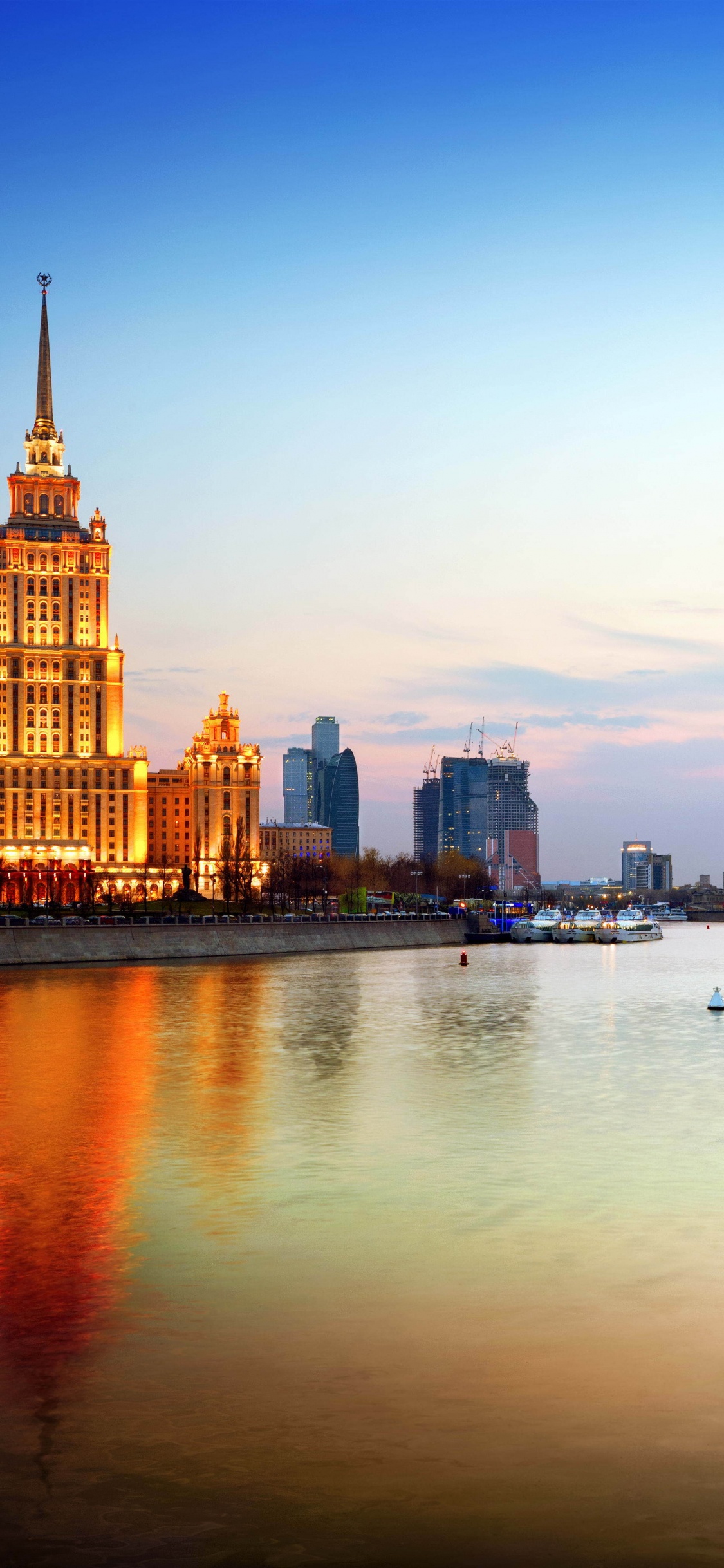 City Skyline Across Body of Water During Daytime. Wallpaper in 1125x2436 Resolution