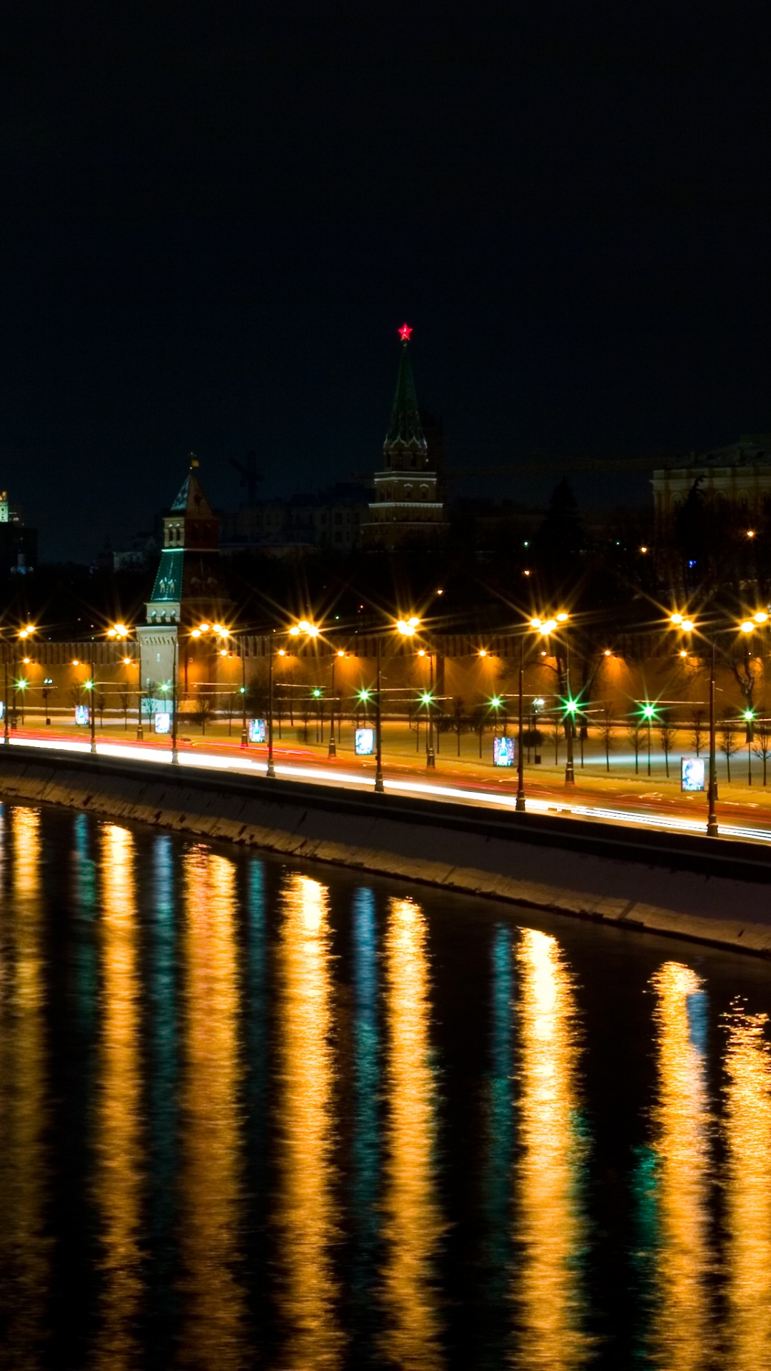 Lighted City Buildings Near Body of Water During Night Time. Wallpaper in 1080x1920 Resolution