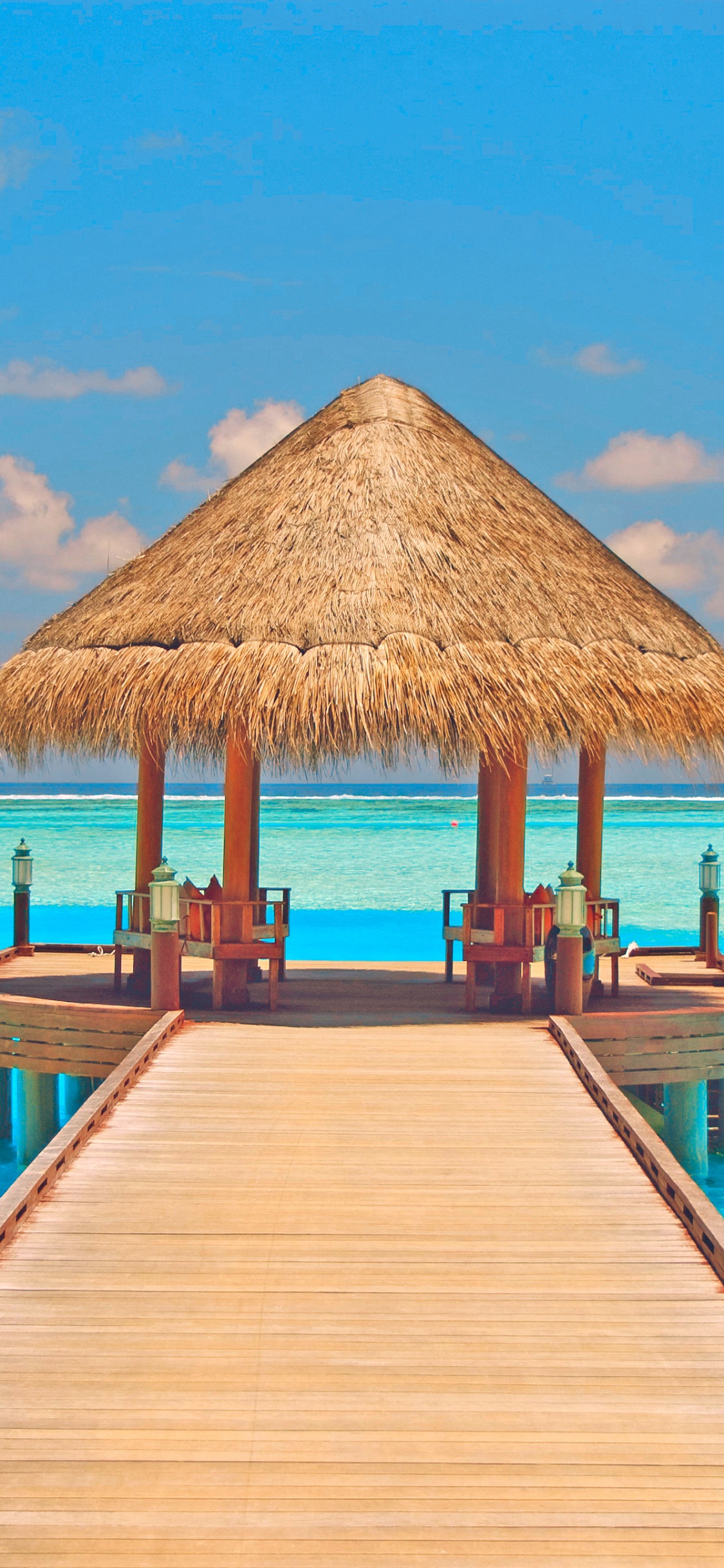 Brown Wooden Beach House on Beach During Daytime. Wallpaper in 1125x2436 Resolution