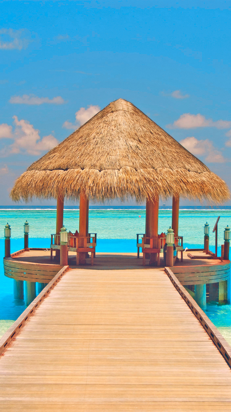 Brown Wooden Beach House on Beach During Daytime. Wallpaper in 750x1334 Resolution