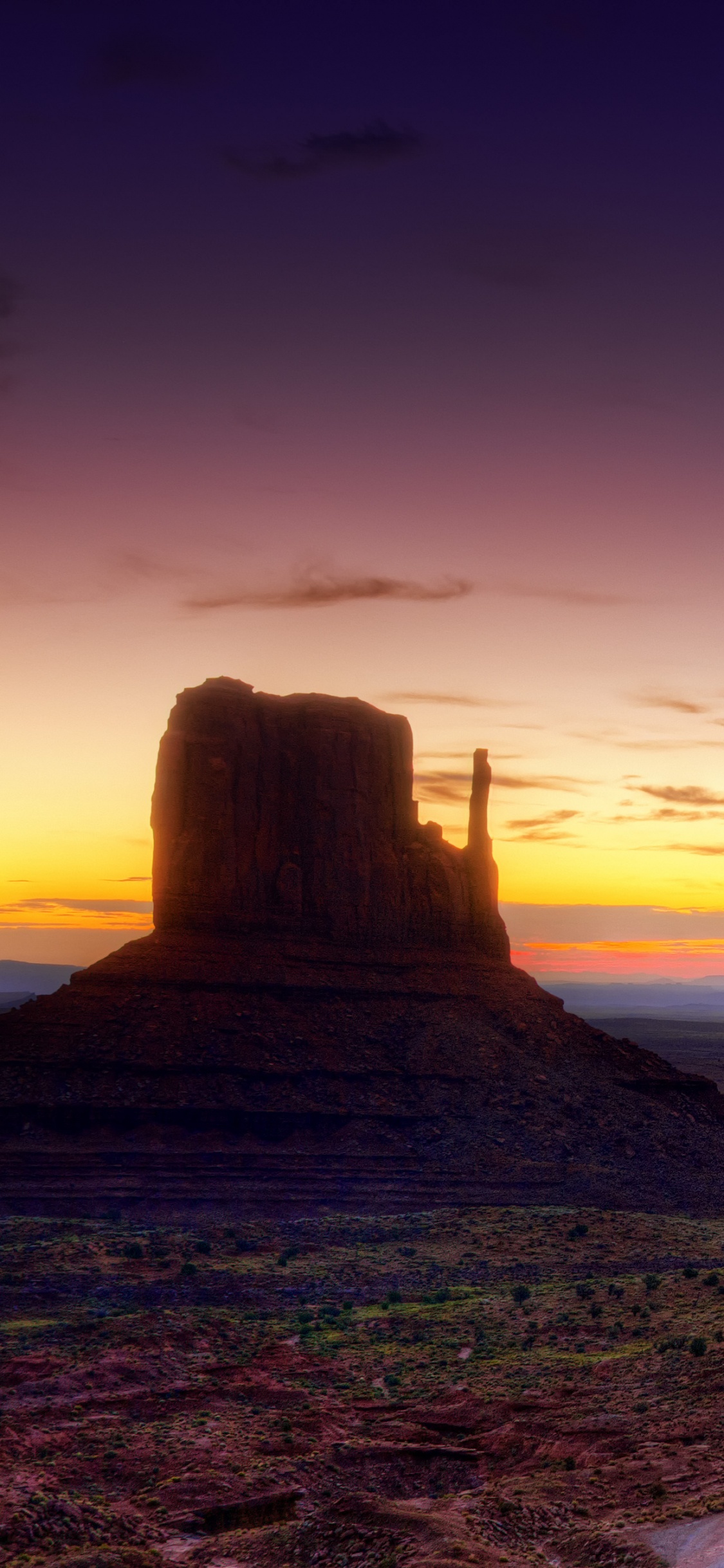 Brown Sand Near Green Mountain During Sunset. Wallpaper in 1125x2436 Resolution