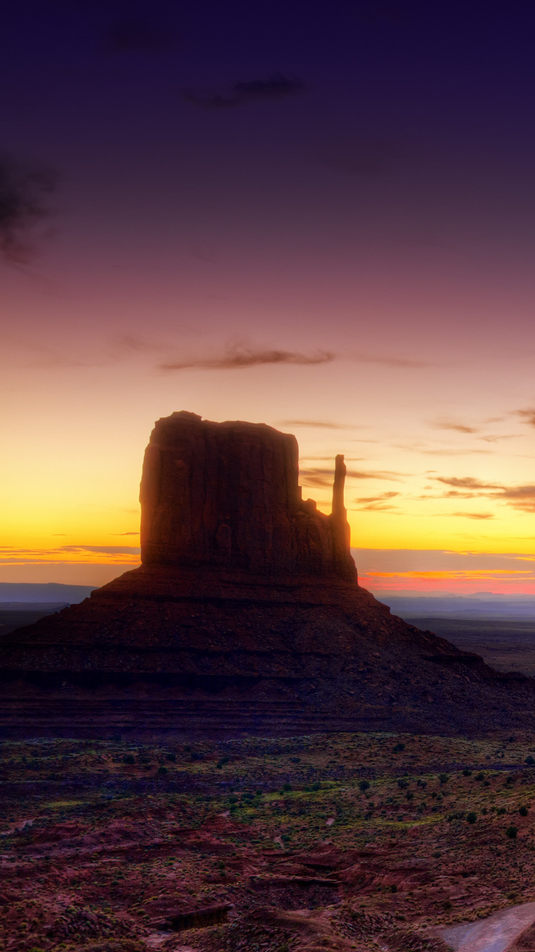 Brown Sand Near Green Mountain During Sunset. Wallpaper in 750x1334 Resolution
