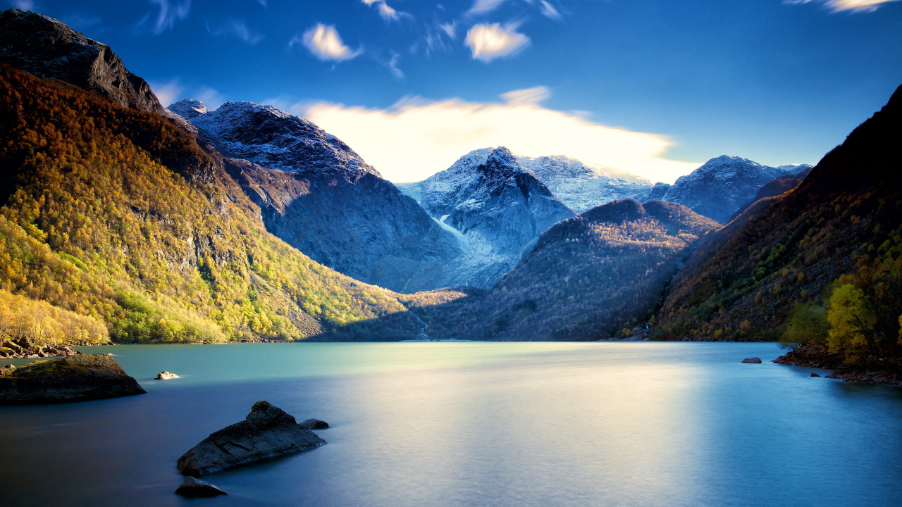 Montañas Verdes y Blancas Junto al Cuerpo de Agua Bajo un Cielo Azul Durante el Día. Wallpaper in 1280x720 Resolution
