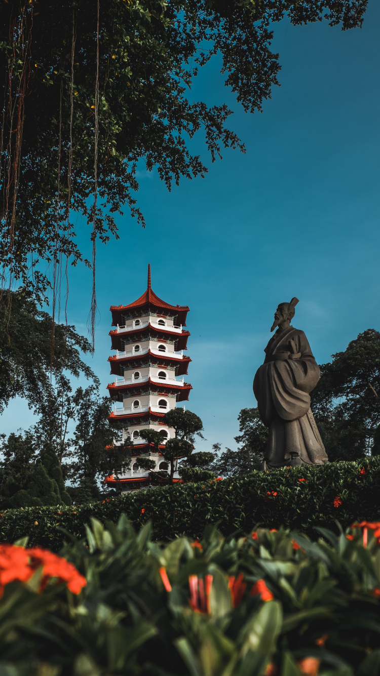 Brown and Black Concrete Statue Near Trees During Daytime. Wallpaper in 750x1334 Resolution