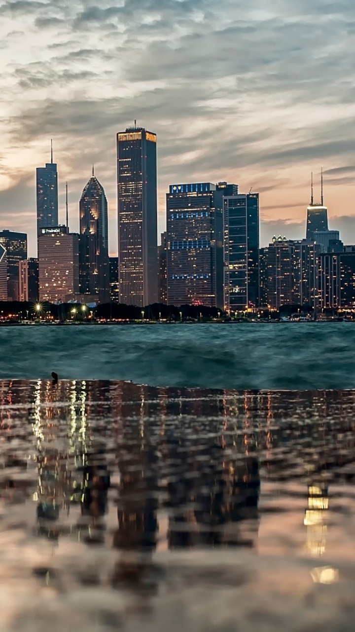 City Skyline Across Body of Water During Daytime. Wallpaper in 720x1280 Resolution