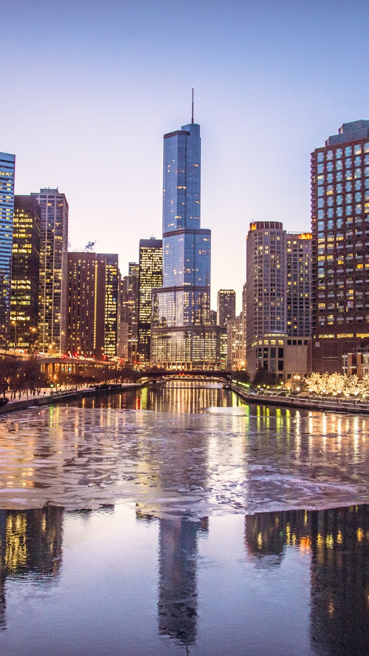 City Skyline Across Body of Water During Night Time. Wallpaper in 720x1280 Resolution