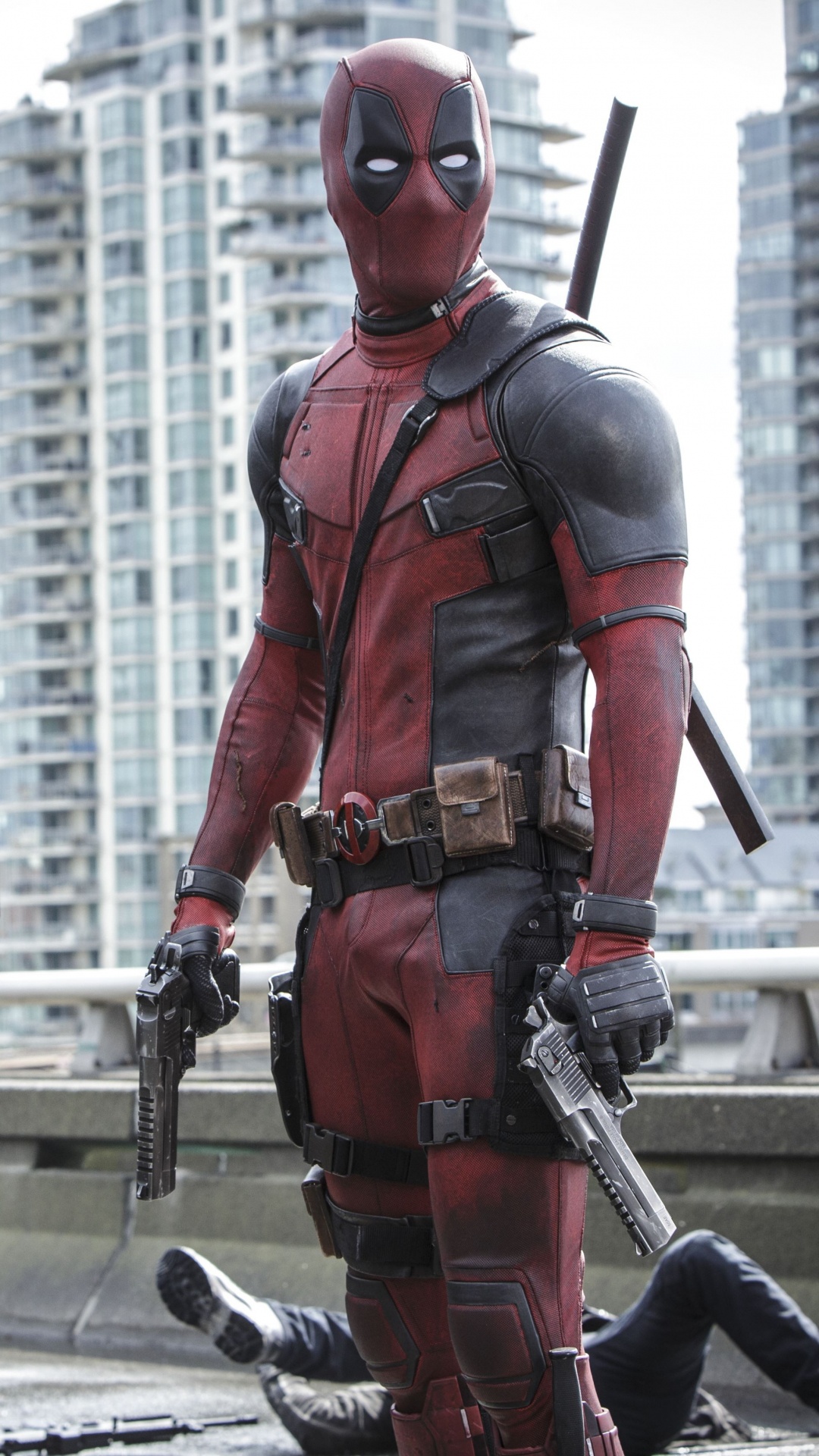 Man in Red and Black Suit Holding Black and Gray Rifle. Wallpaper in 1080x1920 Resolution