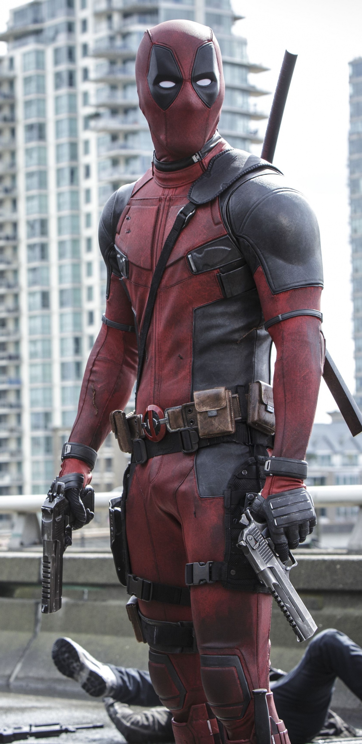 Man in Red and Black Suit Holding Black and Gray Rifle. Wallpaper in 1440x2960 Resolution