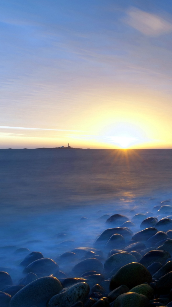 Green and Black Stones Near Sea During Sunset. Wallpaper in 720x1280 Resolution