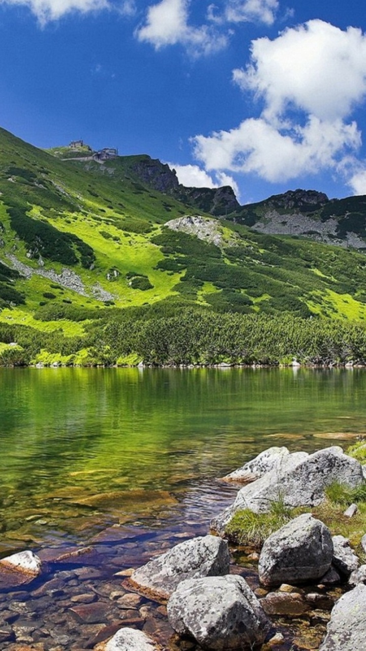 Green Mountain Beside Lake Under Blue Sky During Daytime. Wallpaper in 720x1280 Resolution