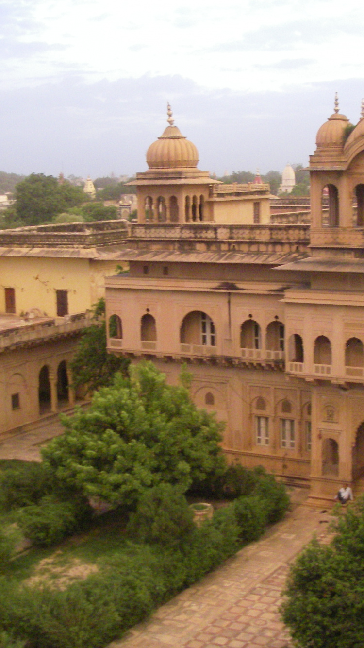 Beige Concrete Building Near Green Trees During Daytime. Wallpaper in 750x1334 Resolution