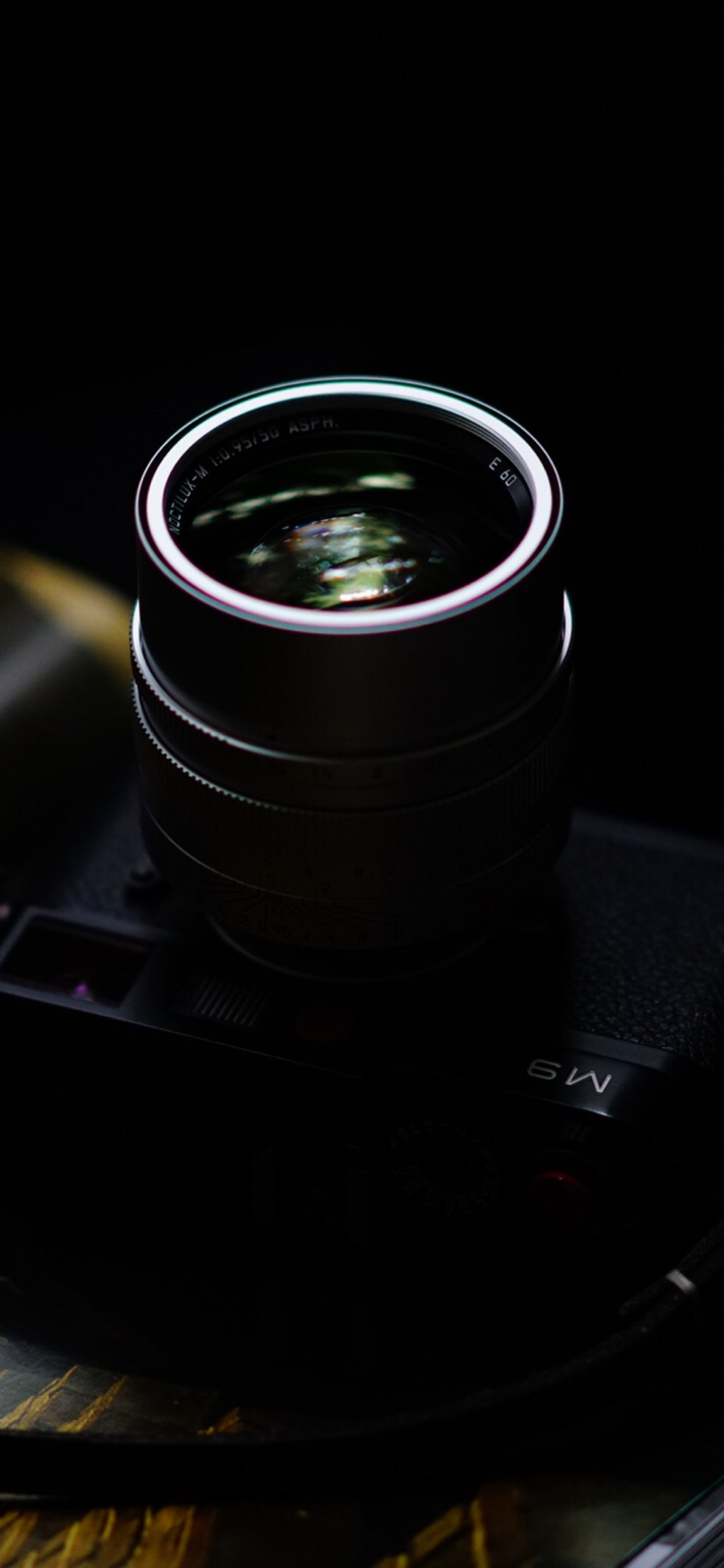 Black Camera Lens on Black Surface. Wallpaper in 1242x2688 Resolution