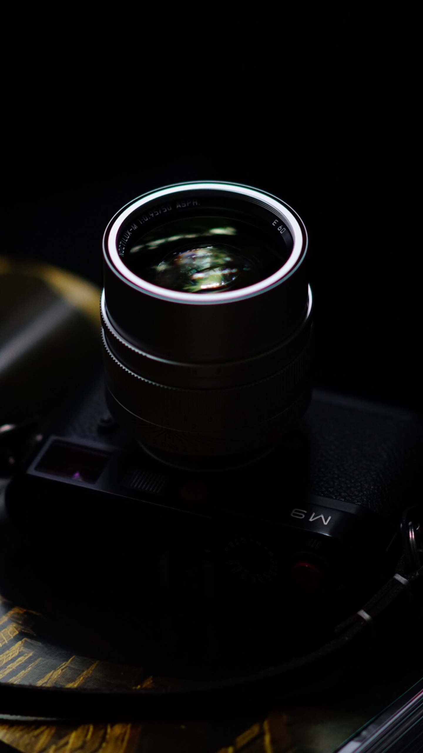 Black Camera Lens on Black Surface. Wallpaper in 1440x2560 Resolution