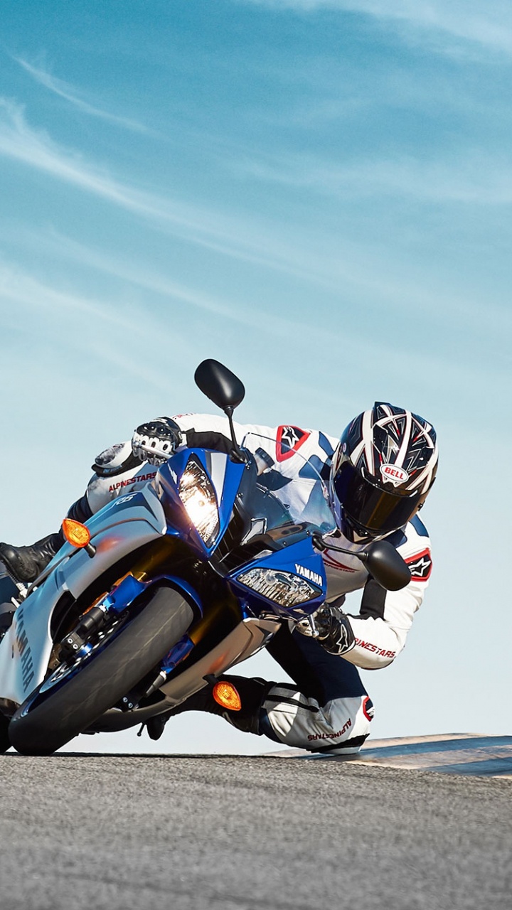 Man in Blue and White Sports Bike Suit Riding on Blue Sports Bike on Gray Asphalt. Wallpaper in 720x1280 Resolution