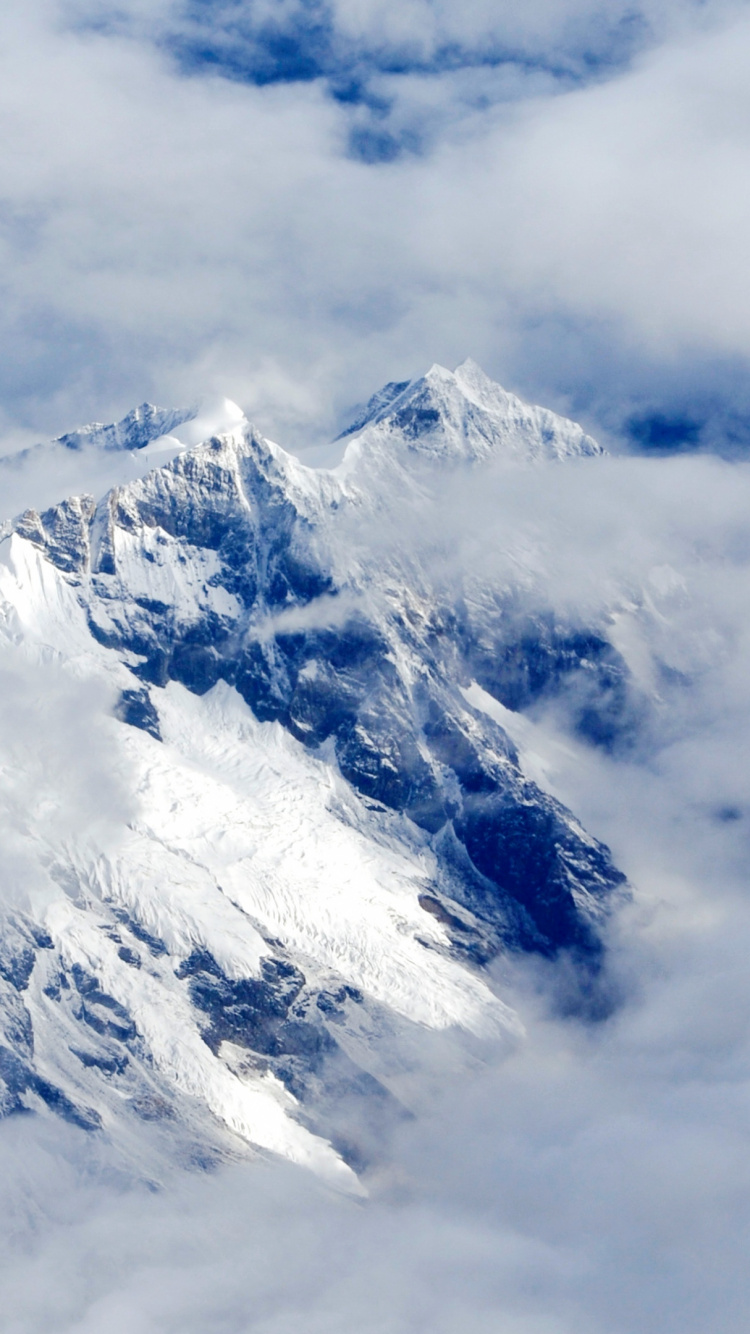 Snow Covered Mountain Under Cloudy Sky During Daytime. Wallpaper in 750x1334 Resolution