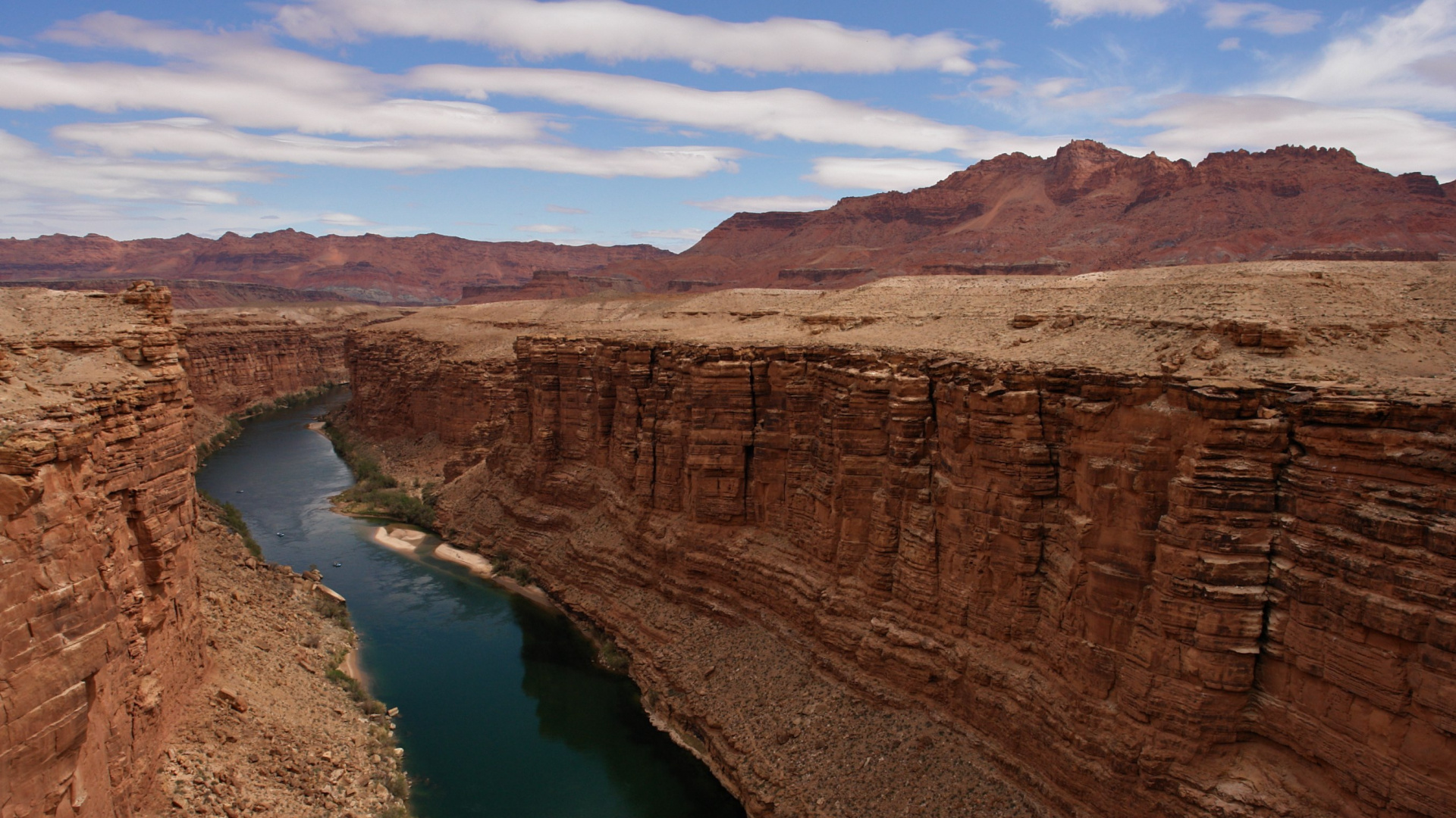 Brown Rock Formation Beside Lake During Daytime. Wallpaper in 1920x1080 Resolution
