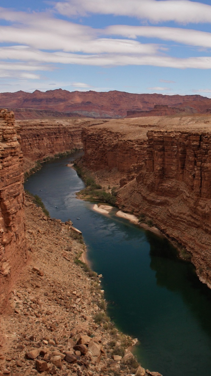 Brown Rock Formation Beside Lake During Daytime. Wallpaper in 720x1280 Resolution