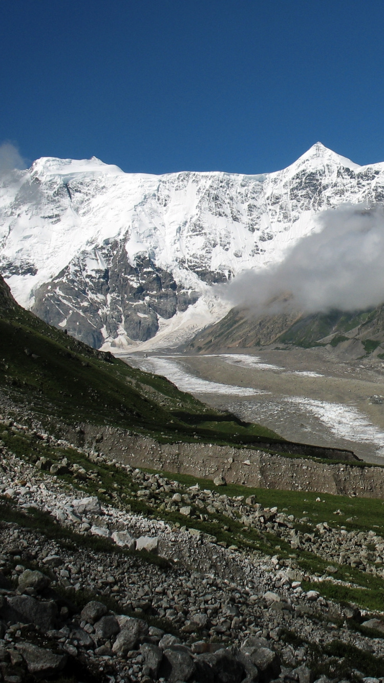 Green Grass Covered Mountain Under Blue Sky During Daytime. Wallpaper in 750x1334 Resolution