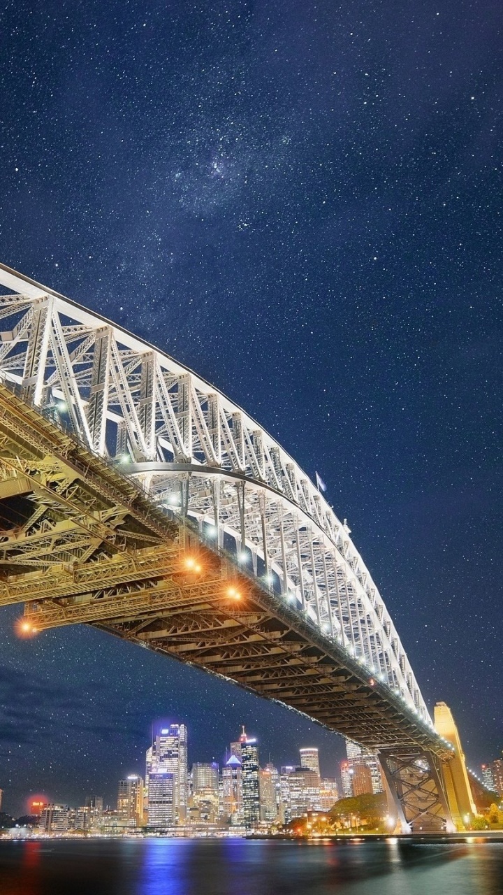 Graue Stahlbrücke Unter Blauem Himmel Während Der Nacht. Wallpaper in 720x1280 Resolution