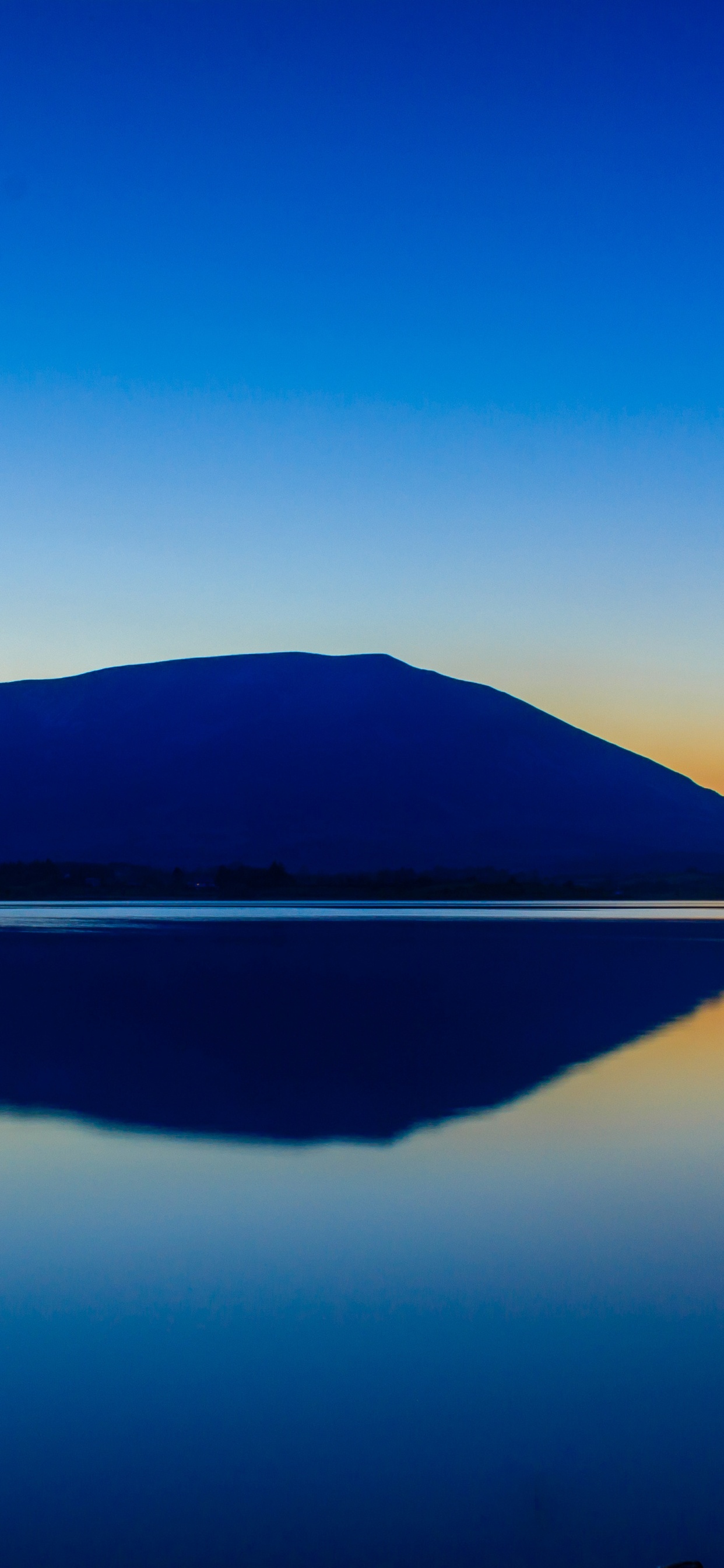 Body of Water Near Mountain Under Blue Sky During Daytime. Wallpaper in 1242x2688 Resolution