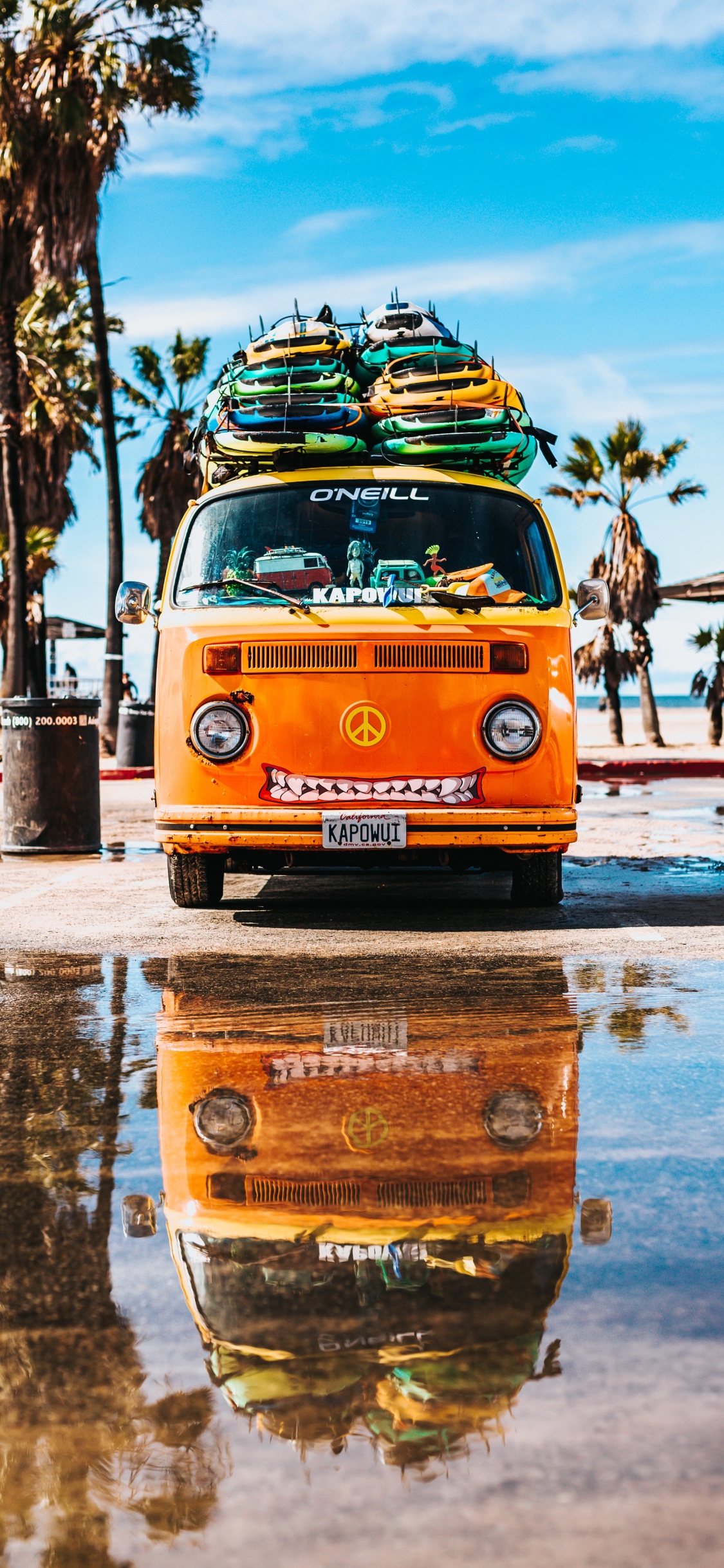 Yellow and Blue Volkswagen T-2 Van on Gray Concrete Road During Daytime. Wallpaper in 1125x2436 Resolution